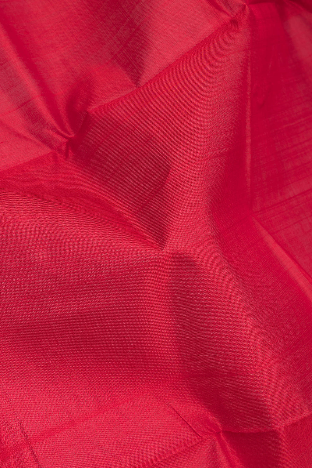 Close up of Red Double Ikat Saree with Plain Body and Temple Border.  displaying folds