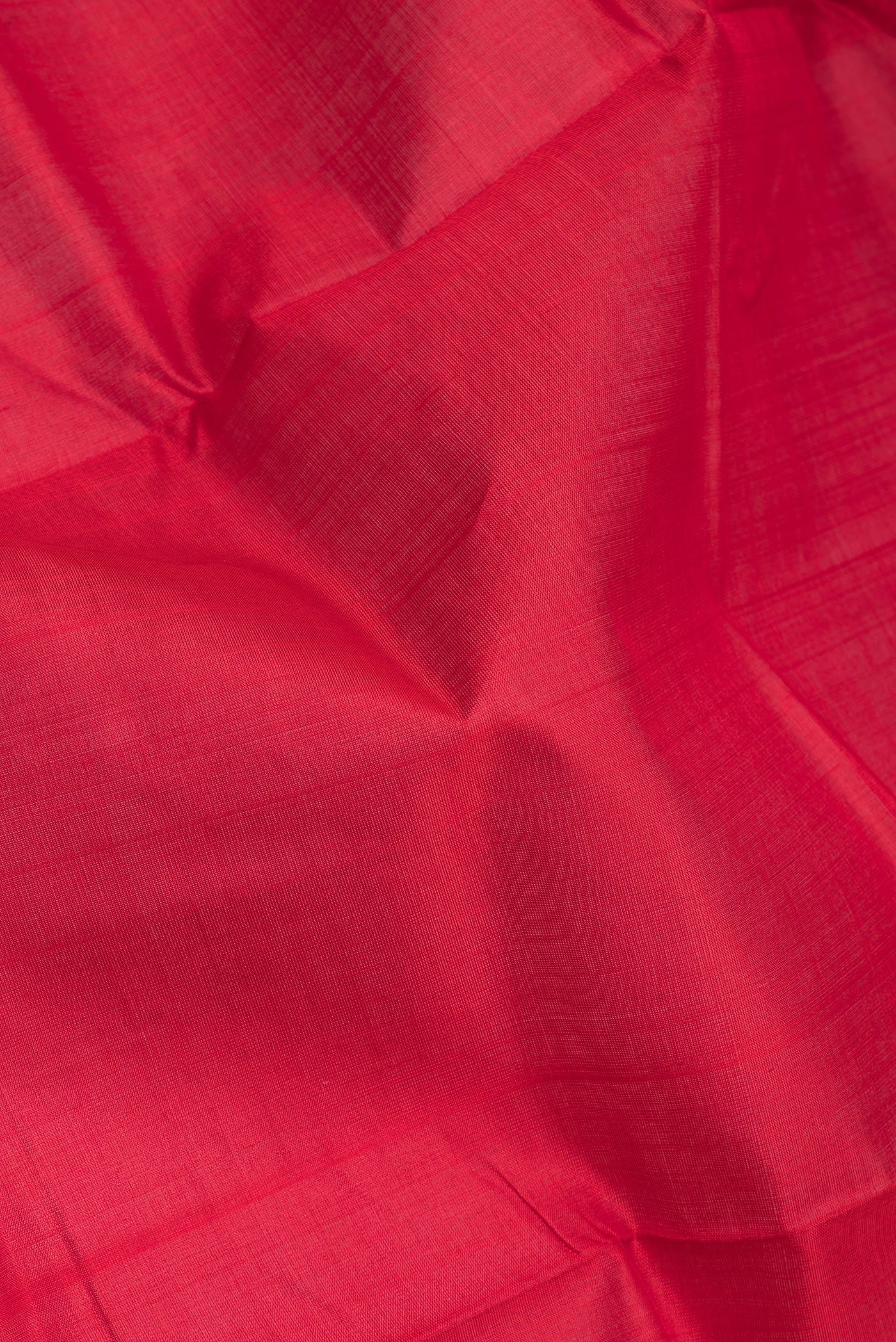 Close up of Red Double Ikat Saree with Plain Body and Temple Border.  displaying folds