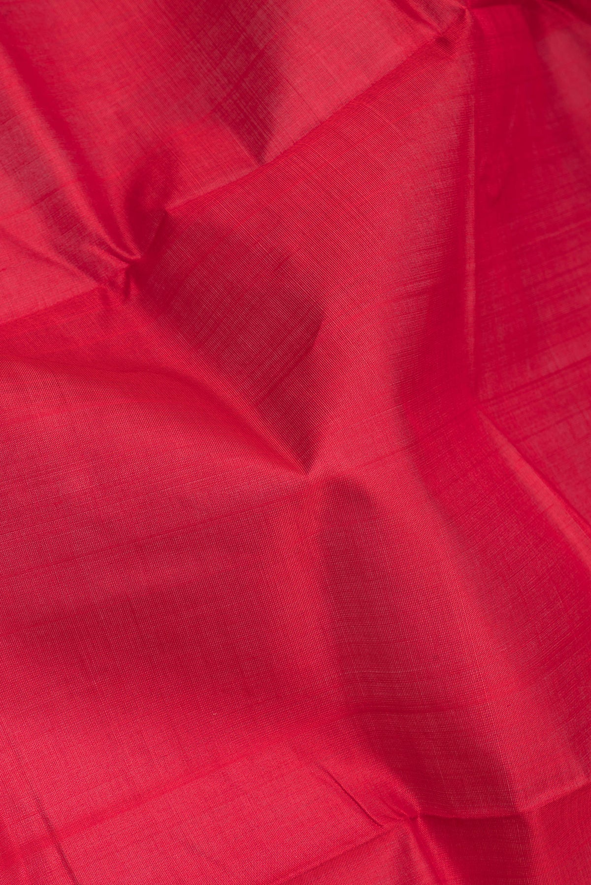 Close up of Red Double Ikat Saree with Plain Body and Temple Border.  displaying folds