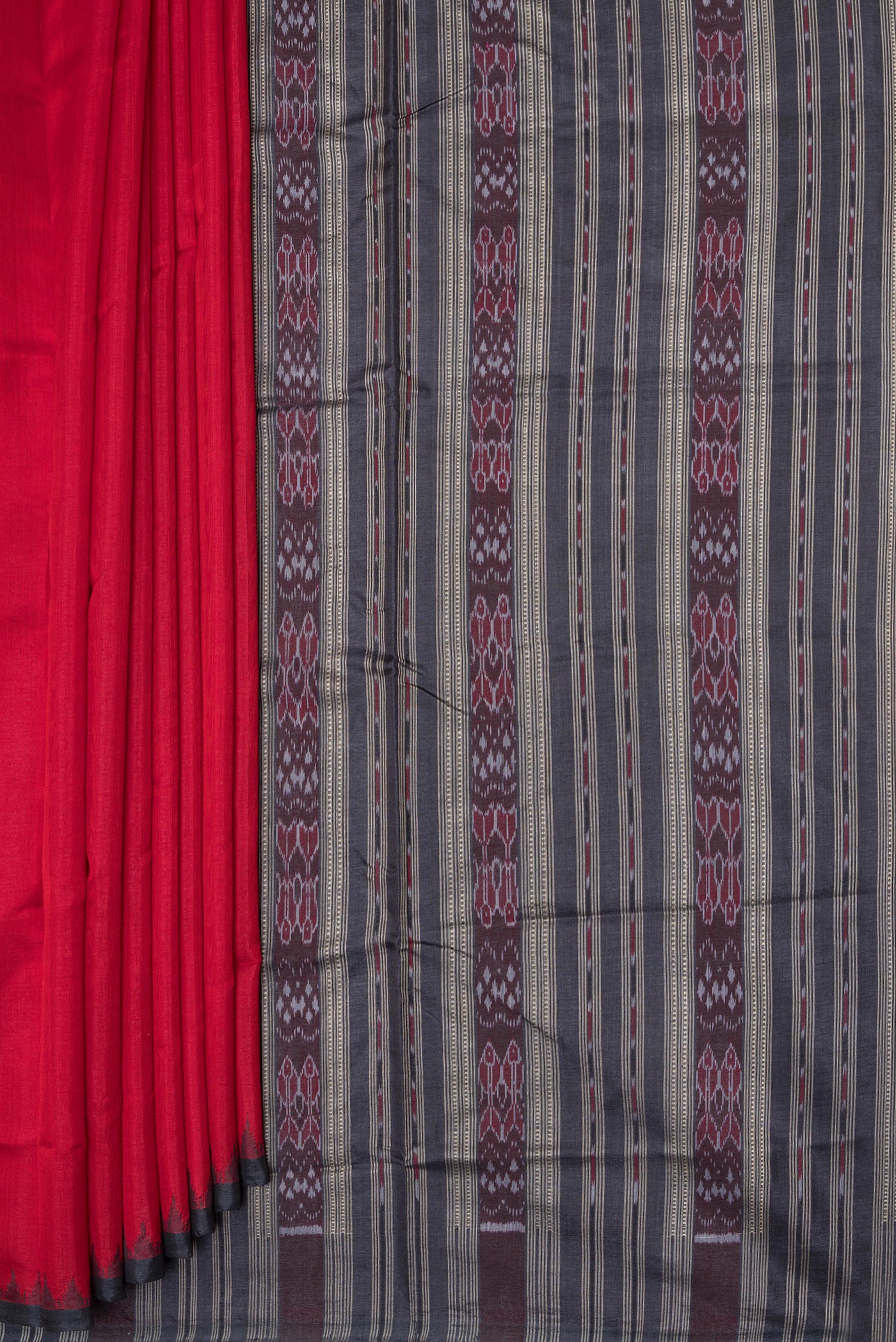Pleats and pallu of Red Double Ikat Saree with Plain Body and Temple Border. 