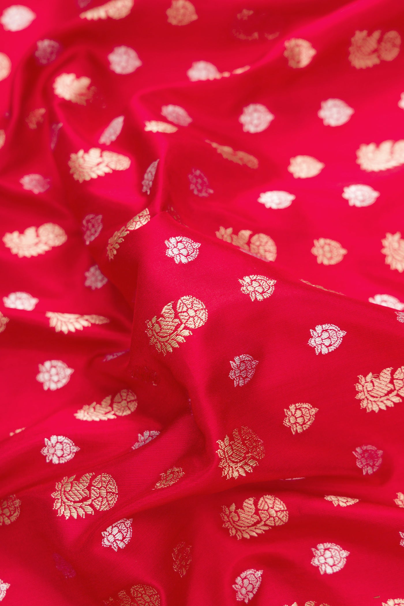 Close up of Red Dual Tone Banarasi Silk Saree with Zari Butta on the body and Fancy Border.  displaying folds