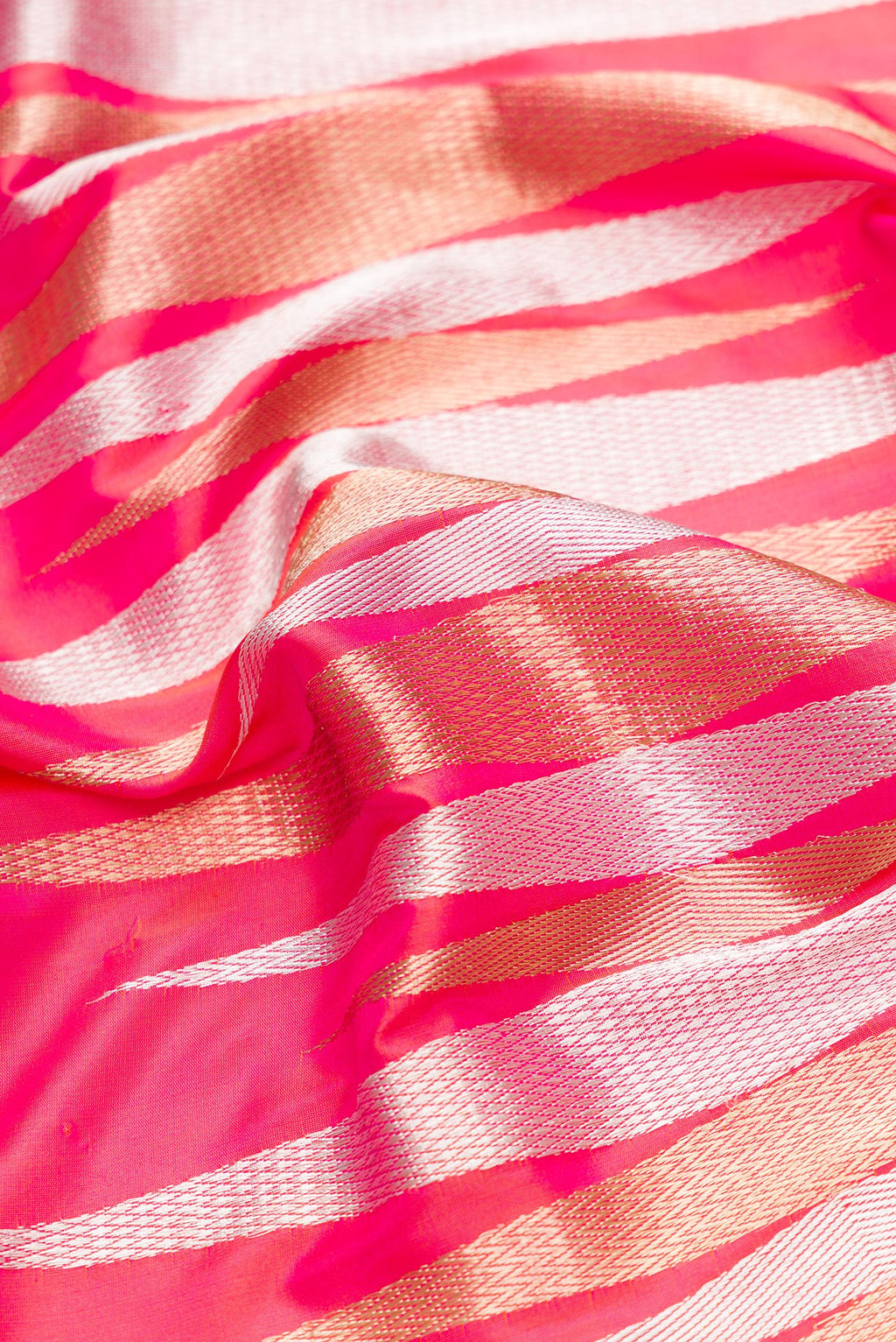 Close up of Coral Dual Tone Banarasi Silk Saree with Zari Butta on the body and Zari Border.  displaying folds