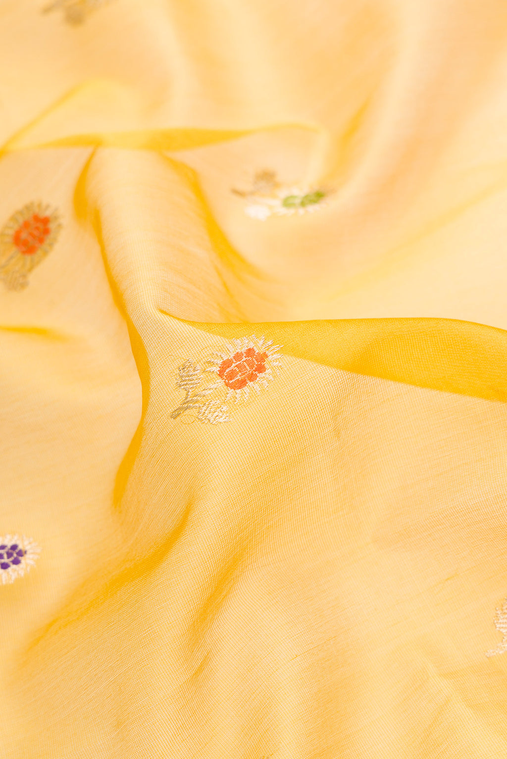Close up of Mehandi Green Dual Tone Organza Silk Saree with Zari And Thread Butta on the body and Zari Border.  displaying folds