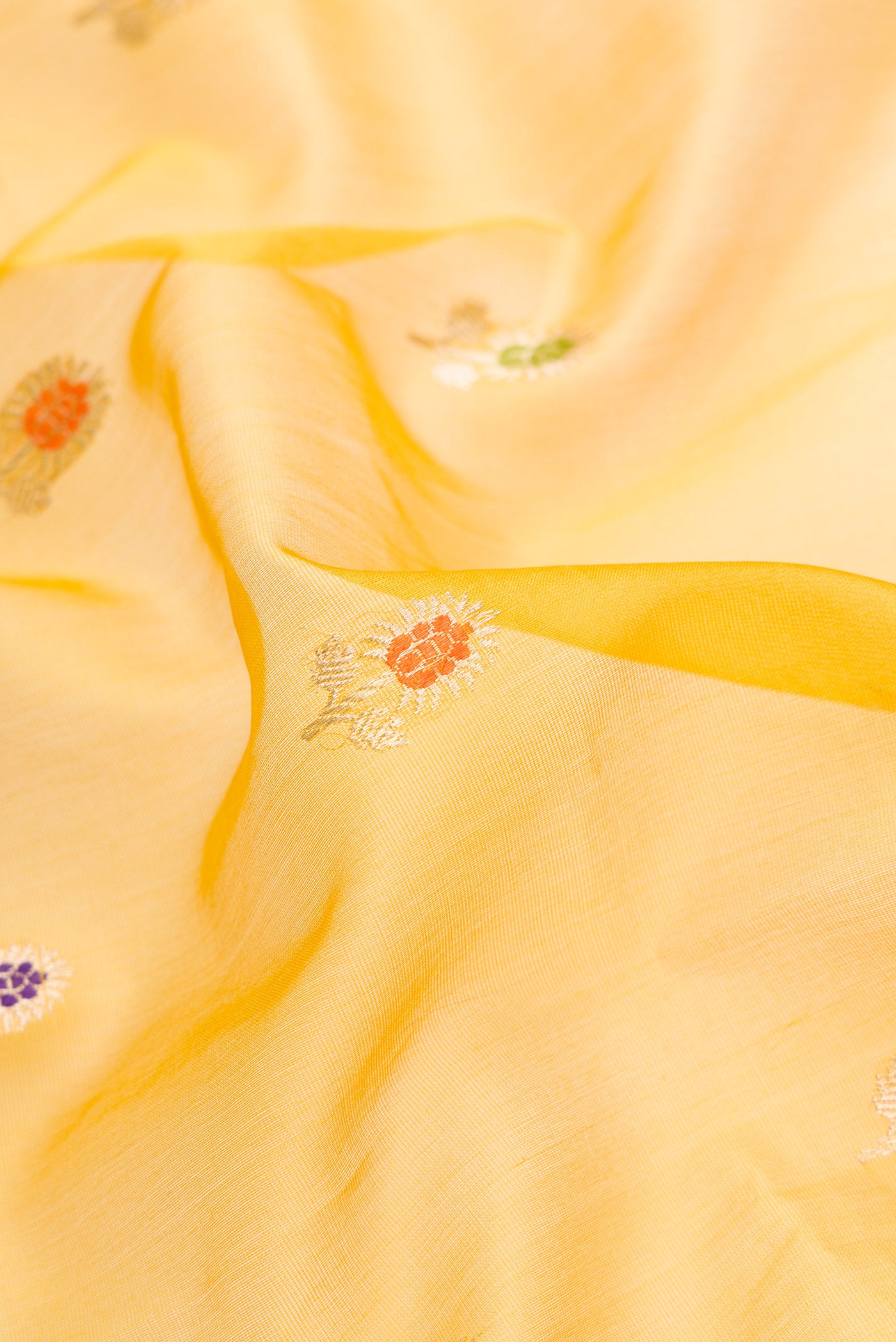 Close up of Mehandi Green Dual Tone Organza Silk Saree with Zari And Thread Butta on the body and Zari Border.  displaying folds