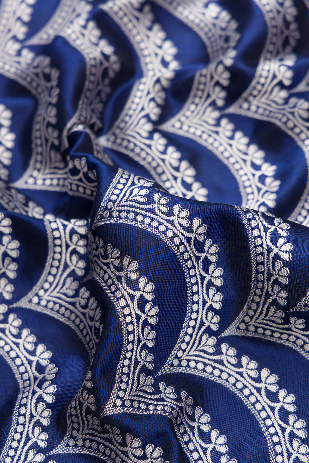 Close up of Navy Blue Dual Tone Banarasi Silk Saree with Stripes on the body and Zari Border.  displaying folds