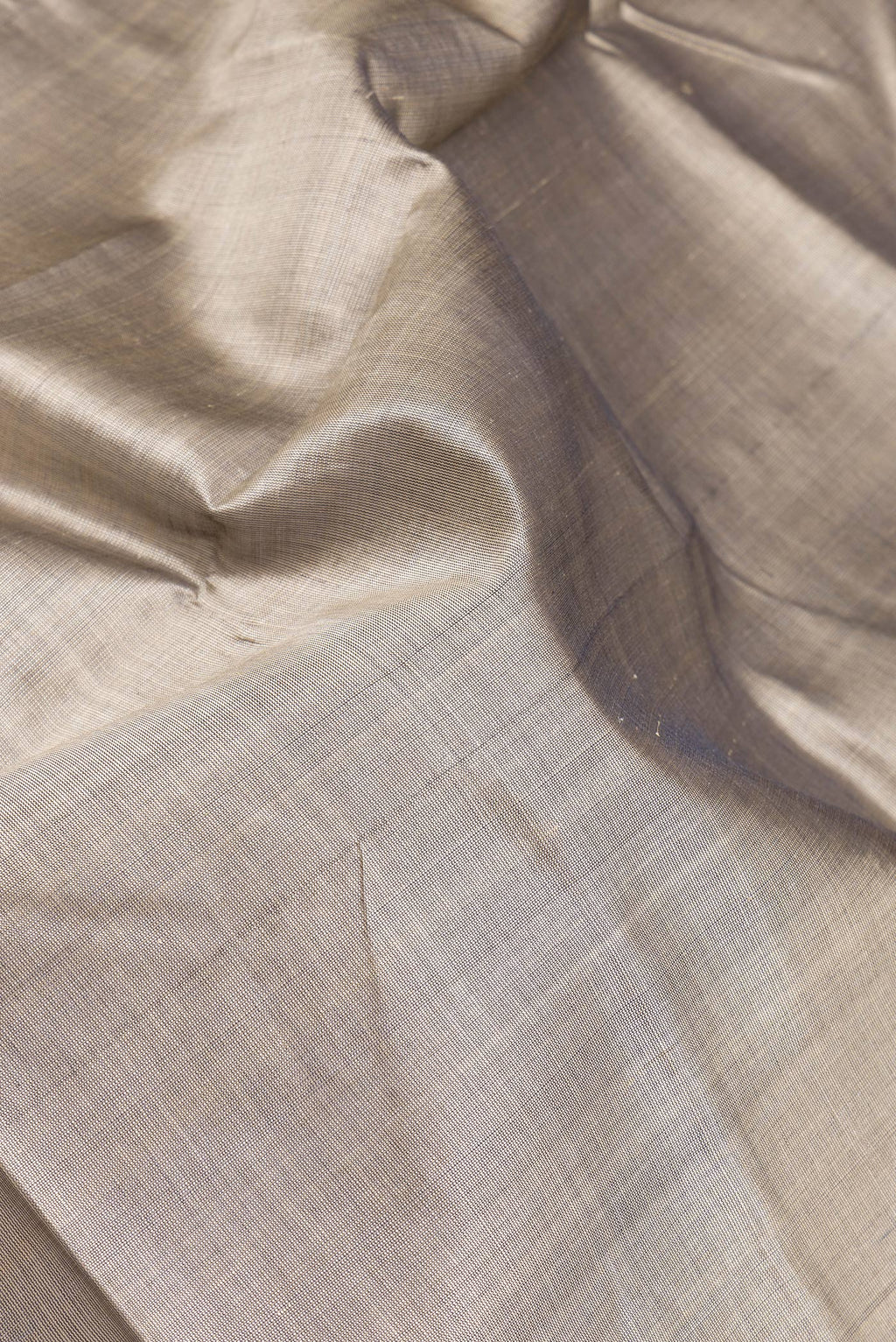 Close up of Grey Double Ikat Saree with Plain Body and Temple Border.  displaying folds
