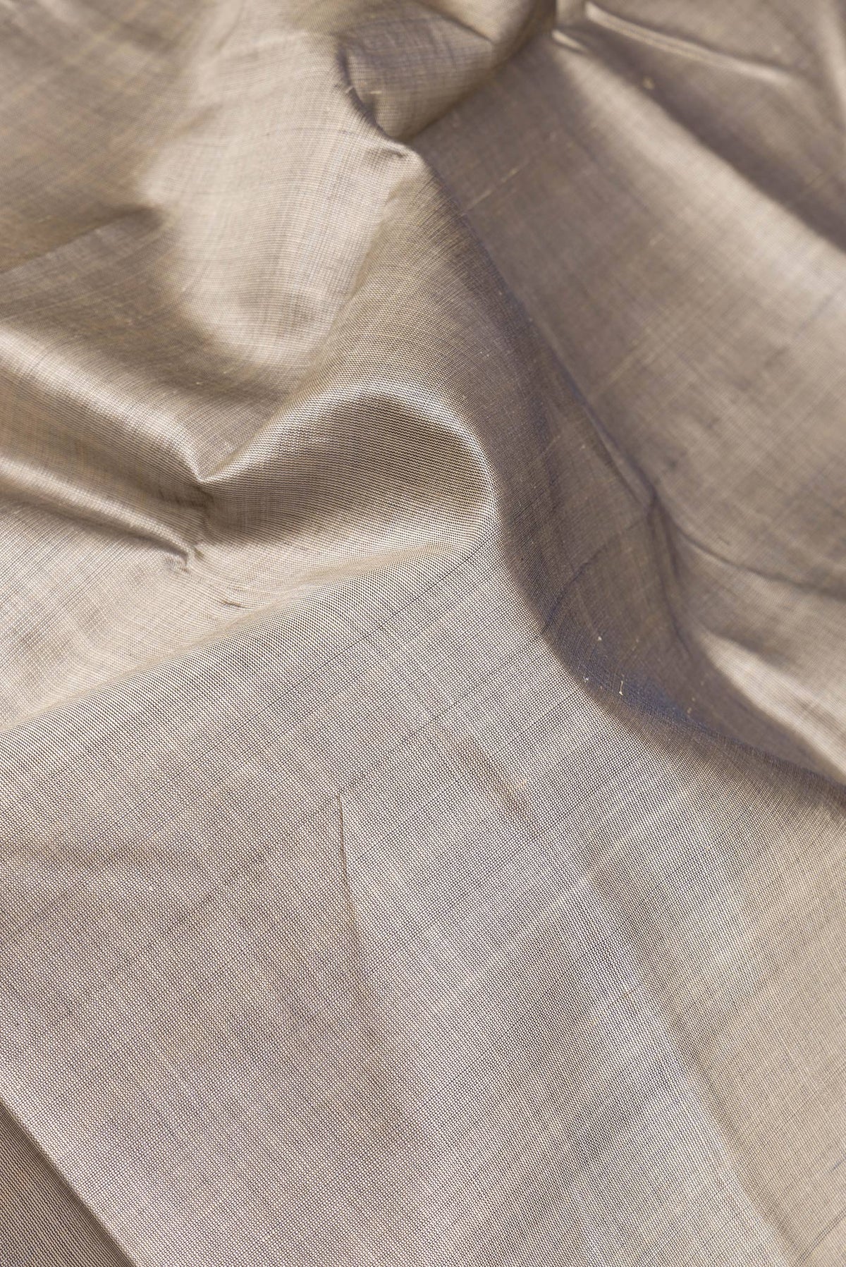 Close up of Grey Double Ikat Saree with Plain Body and Temple Border.  displaying folds