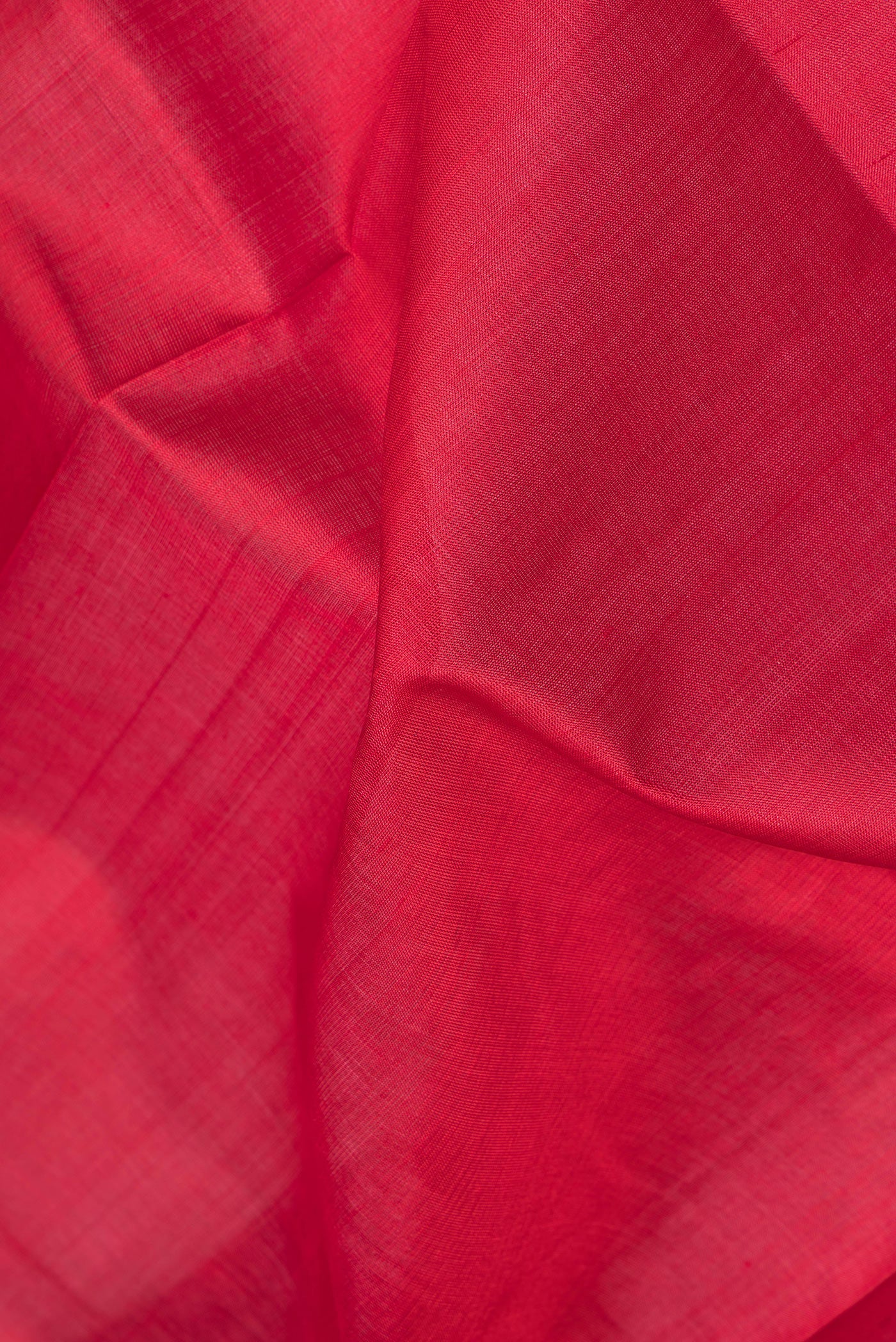 Close up of Red Double Ikat Saree with Plain Body and Temple Border.  displaying folds