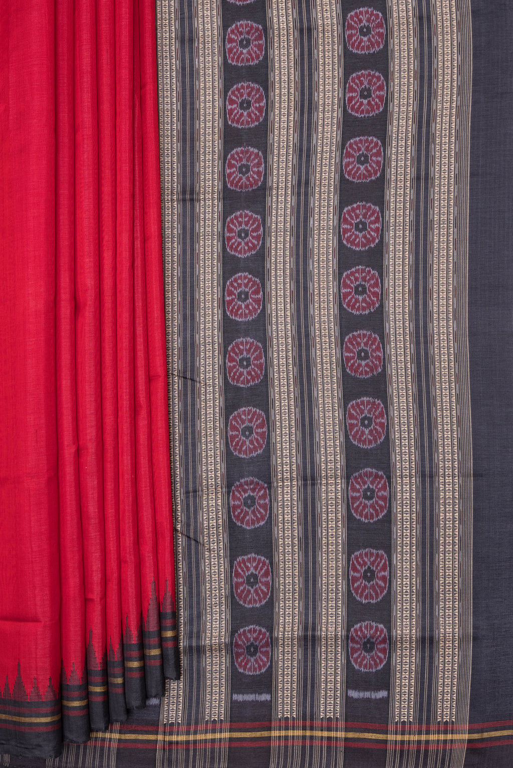 Pleats and pallu of Red Double Ikat Saree with Plain Body and Temple Border. 