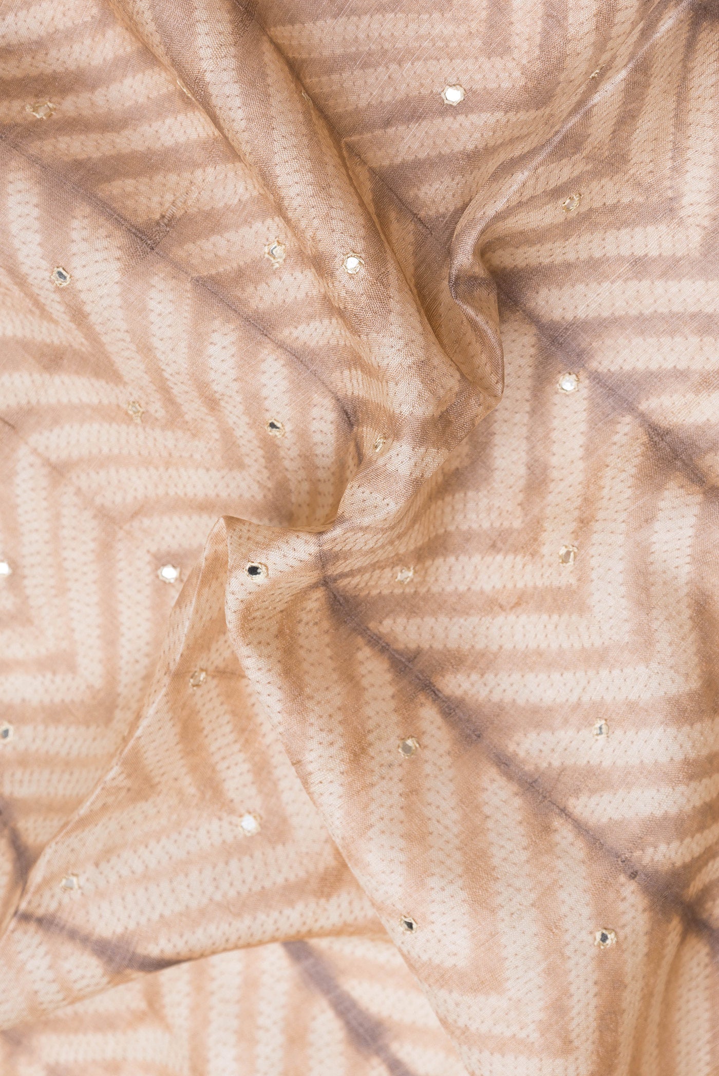 Close up of Golden Peach Dual Tone Tussar Silk Saree with Embroidery on the body and Embroidery Border.  displaying folds