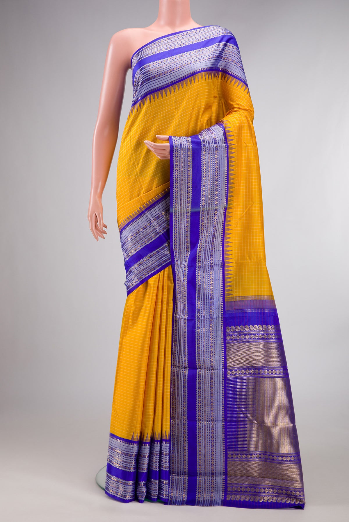 Pure Silk Pure Zari Yellow Kanjivaram Saree with Checked design on the body and Temple Border.  displayed on a mannequin