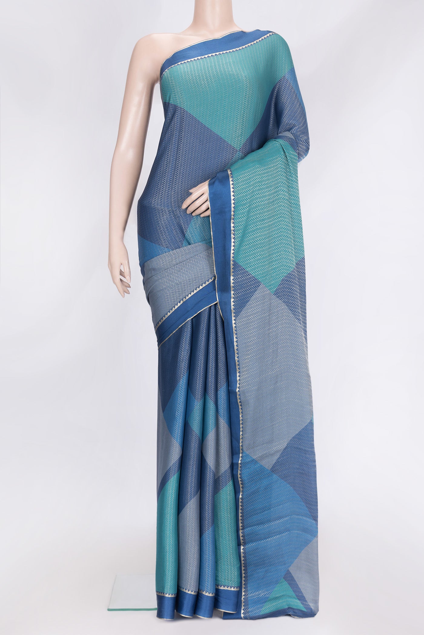 Navy Blue Dual Tone Georgette Saree with Zari Brocade on the body and Zari Border.  displayed on a mannequin