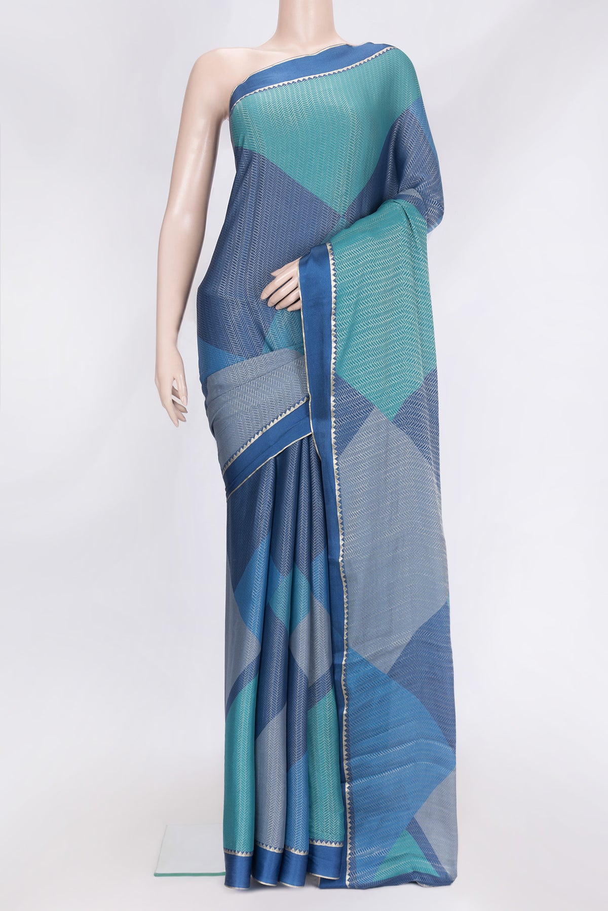 Navy Blue Dual Tone Georgette Saree with Zari Brocade on the body and Zari Border.  displayed on a mannequin