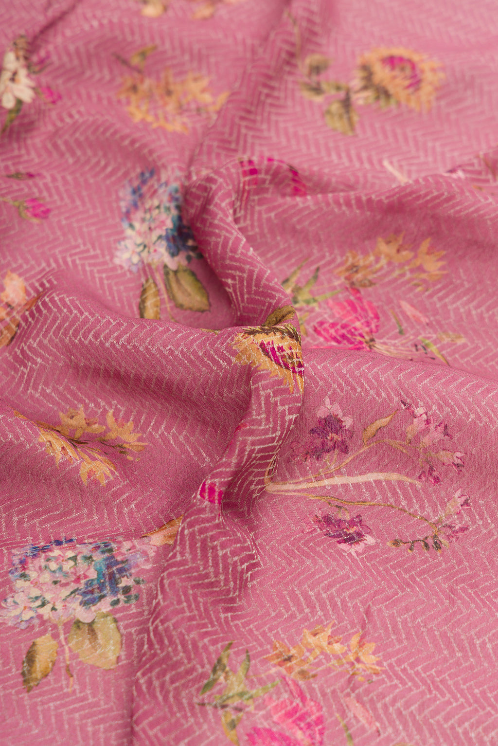 Close up of Rose Gold Dual Tone Mysore Crepe Saree with Printed design on the body and Zari Border.  displaying folds