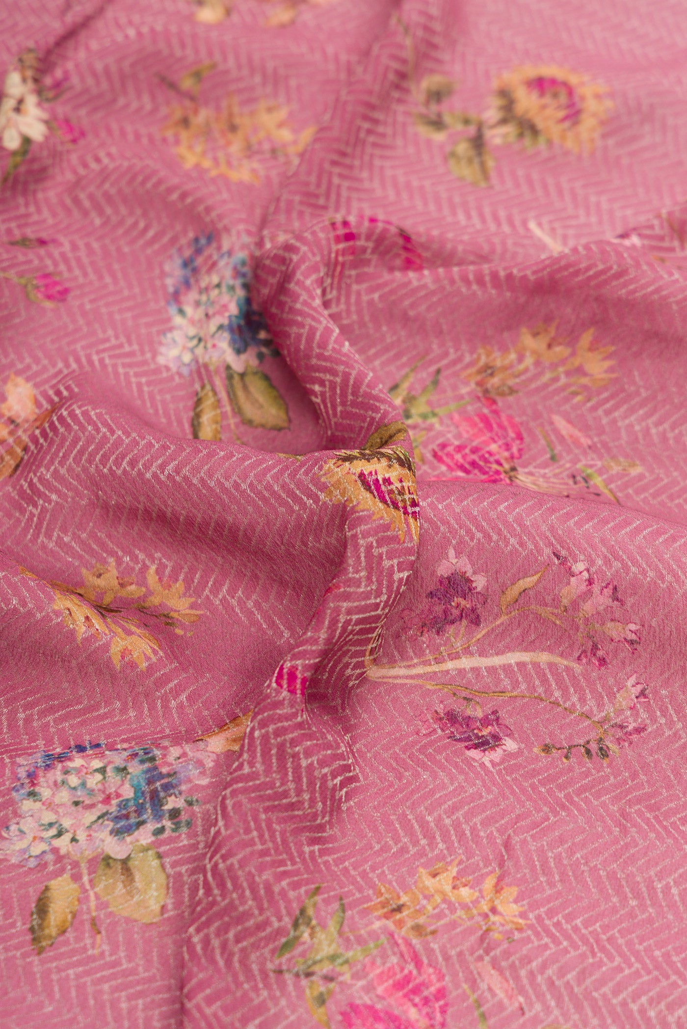 Close up of Rose Gold Dual Tone Mysore Crepe Saree with Printed design on the body and Zari Border.  displaying folds