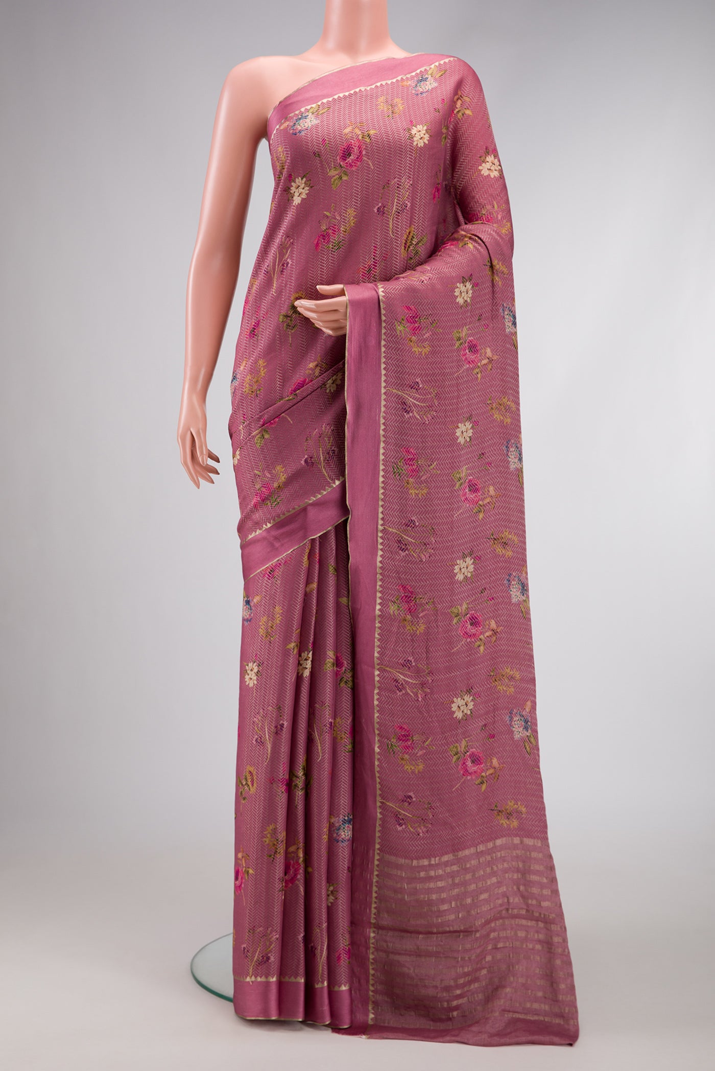 Rose Gold Dual Tone Mysore Crepe Saree with Printed design on the body and Zari Border.  displayed on a mannequin