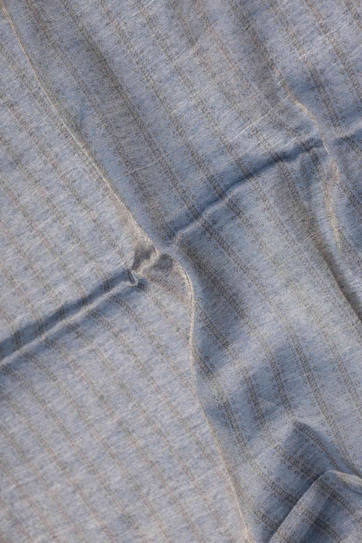 Close up of Blue Dual Tone Tussar Saree with Zari Brocade on the body and Embroidery Border displaying folds