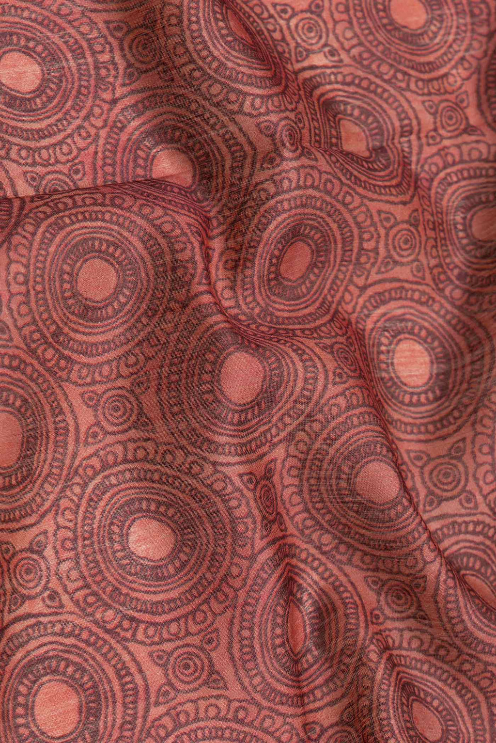 Close up of Maroon Dual Tone Tussar Silk Saree with Printed design on the body and Embroidery Border.  displaying folds