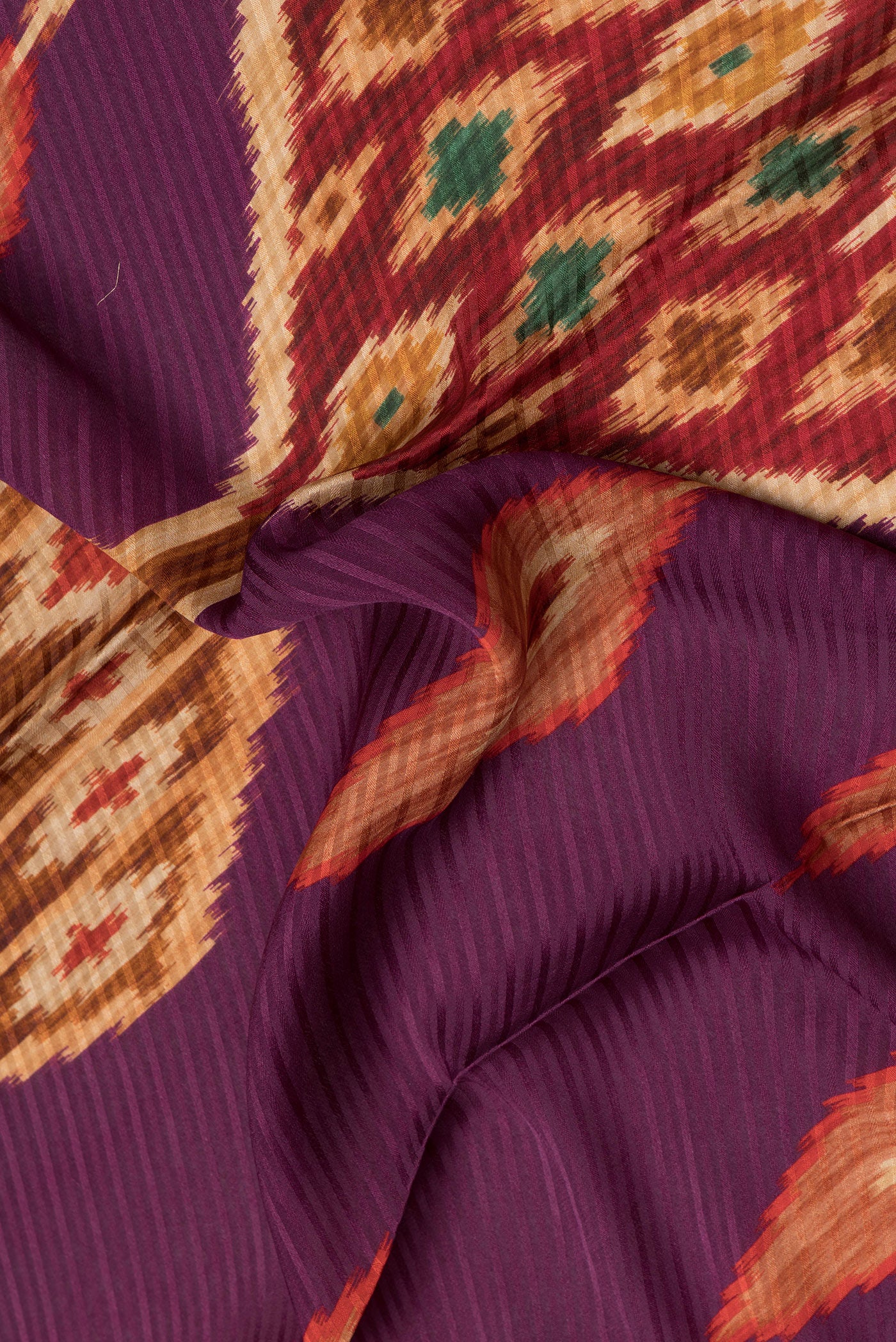 Close up of Purple Mysore Crepe Saree with Printed design on the body and Zari Border.  displaying folds