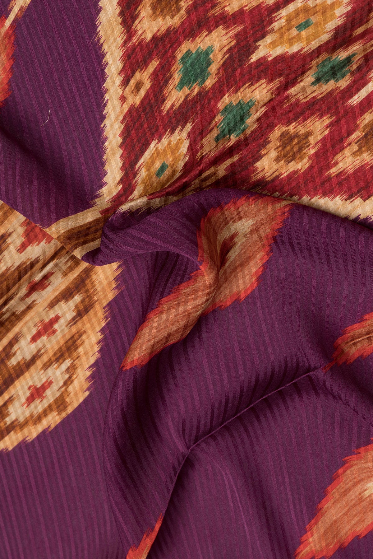 Close up of Purple Mysore Crepe Saree with Printed design on the body and Zari Border.  displaying folds