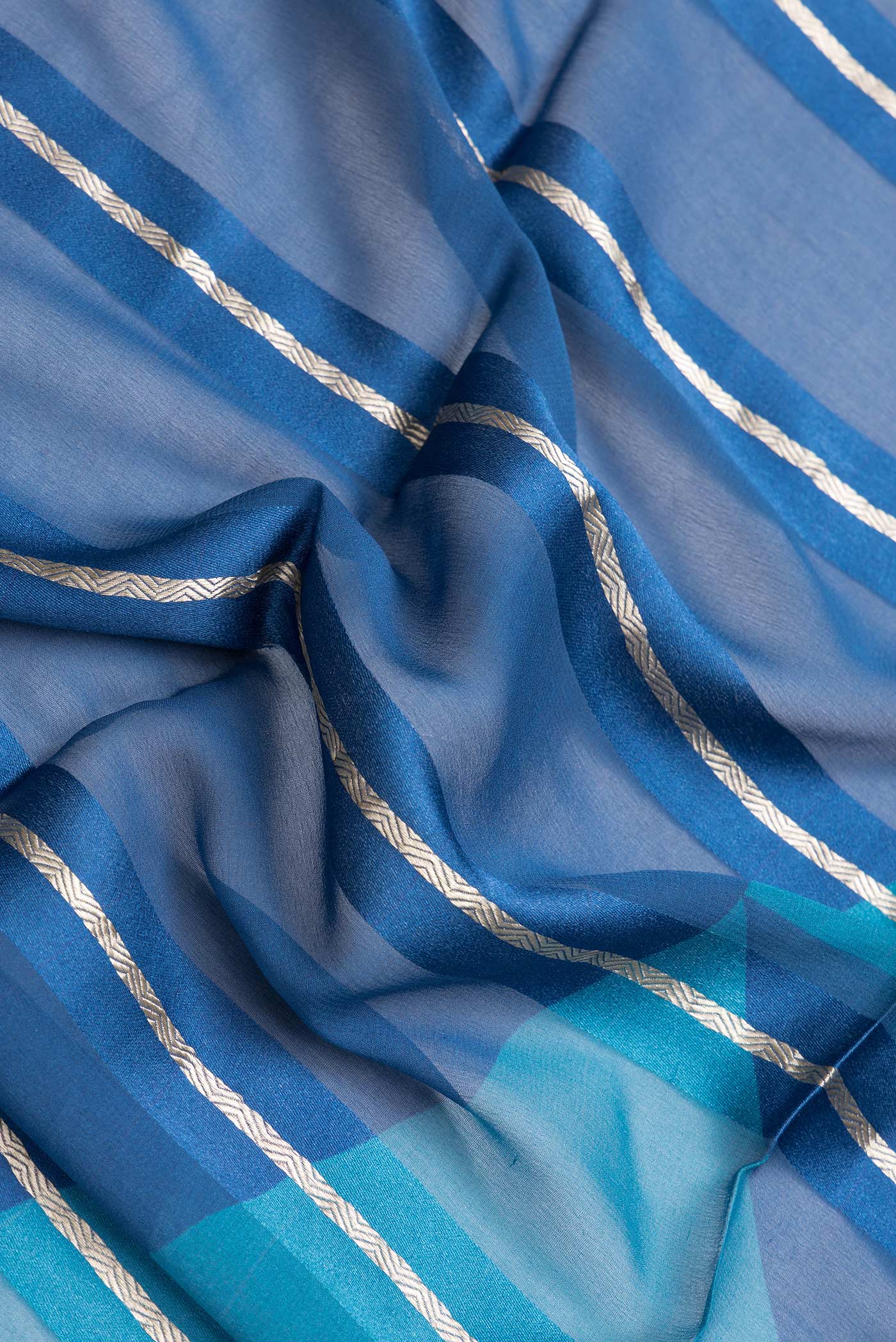 Close up of Peacock Blue Dual Tone Mysore Georgette Saree with Stripes on the body and Zari Border.  displaying folds