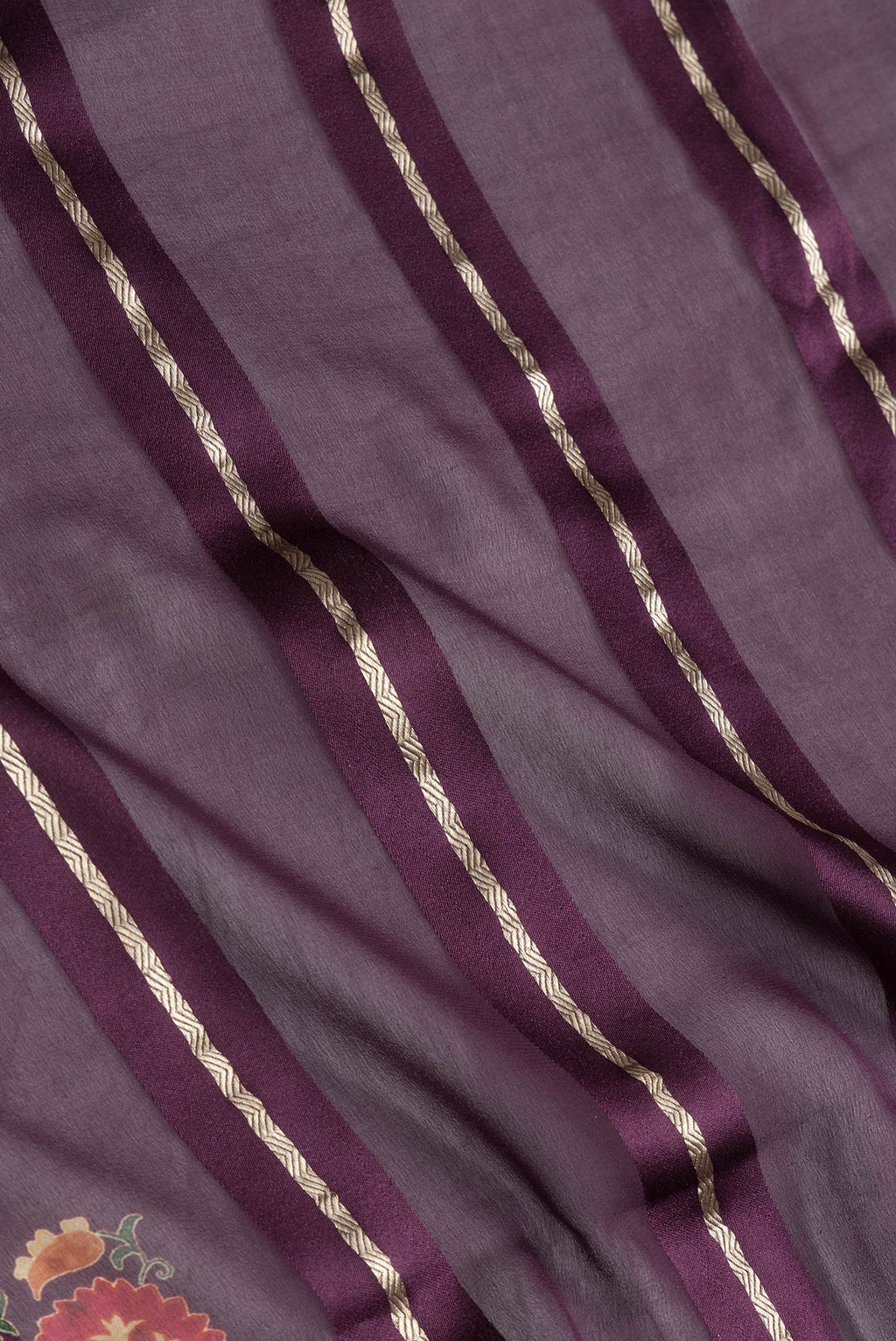 Close up of Burgundy Dual Tone Georgette Saree with Stripes on the body and Printed Border.  displaying folds