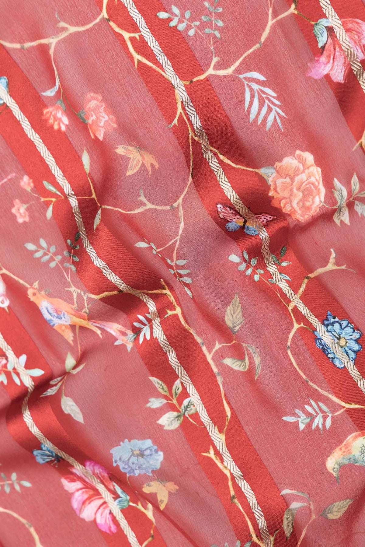Close up of Maroon Dual Tone Mysore Georgette Saree with Printed design on the body and Zari Border displaying folds
