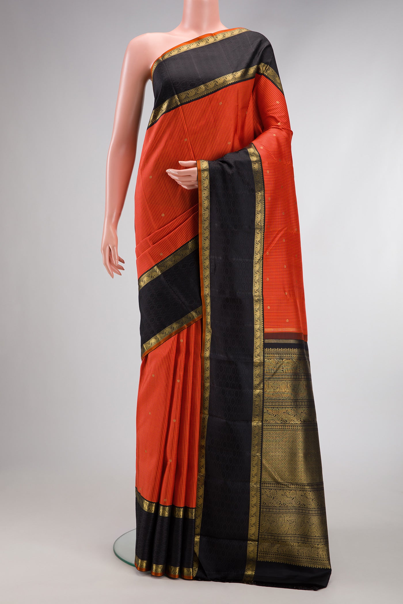Pure Silk Pure Zari Orange Dual Tone Kanchipuram Saree with Checked design on the body and Zari Border.  displayed on a mannequin
