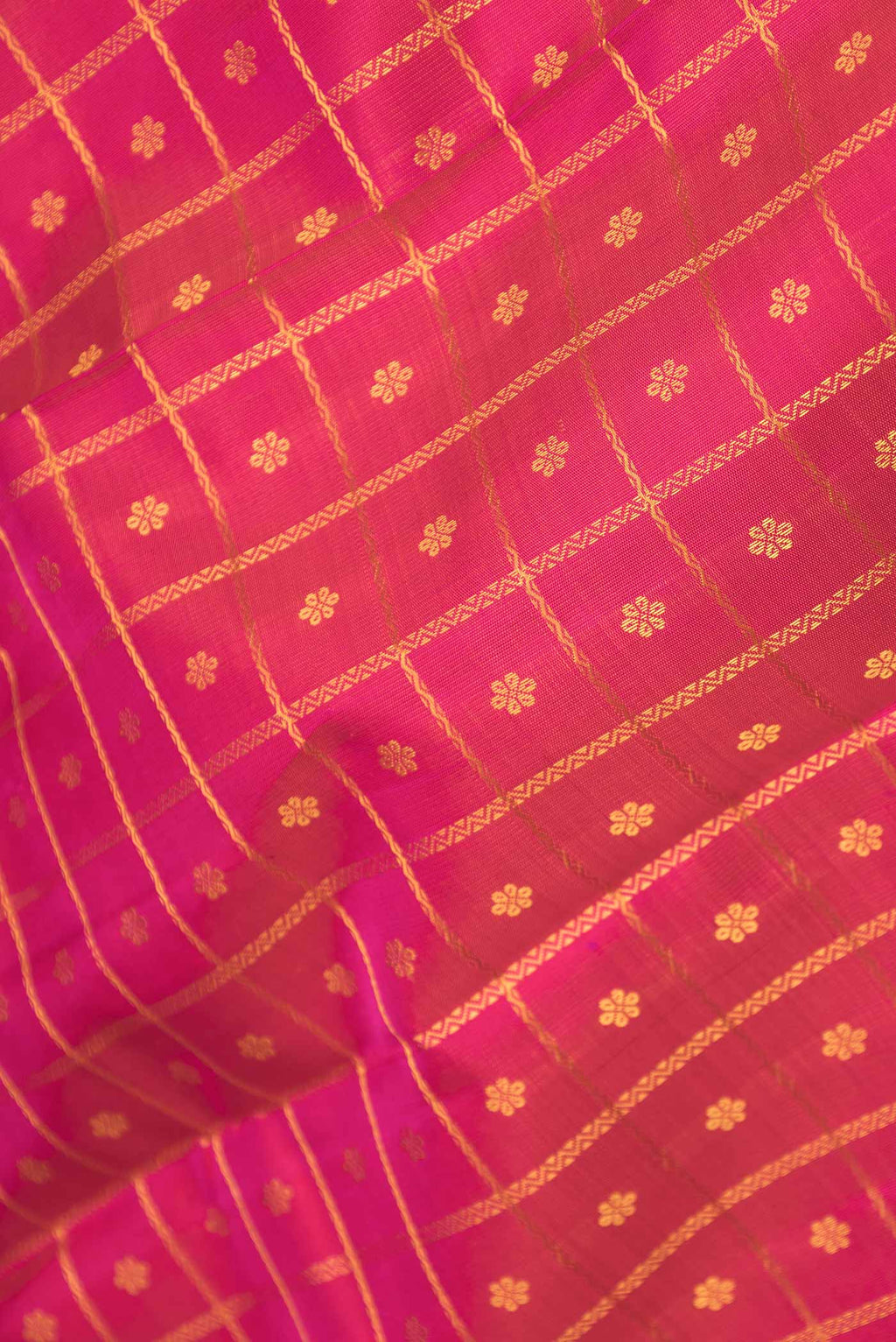 Close up of Pure Silk Pure Zari Pink Dual Tone Kanchipuram Saree with Thread Butta on the body and Zari Border displaying folds