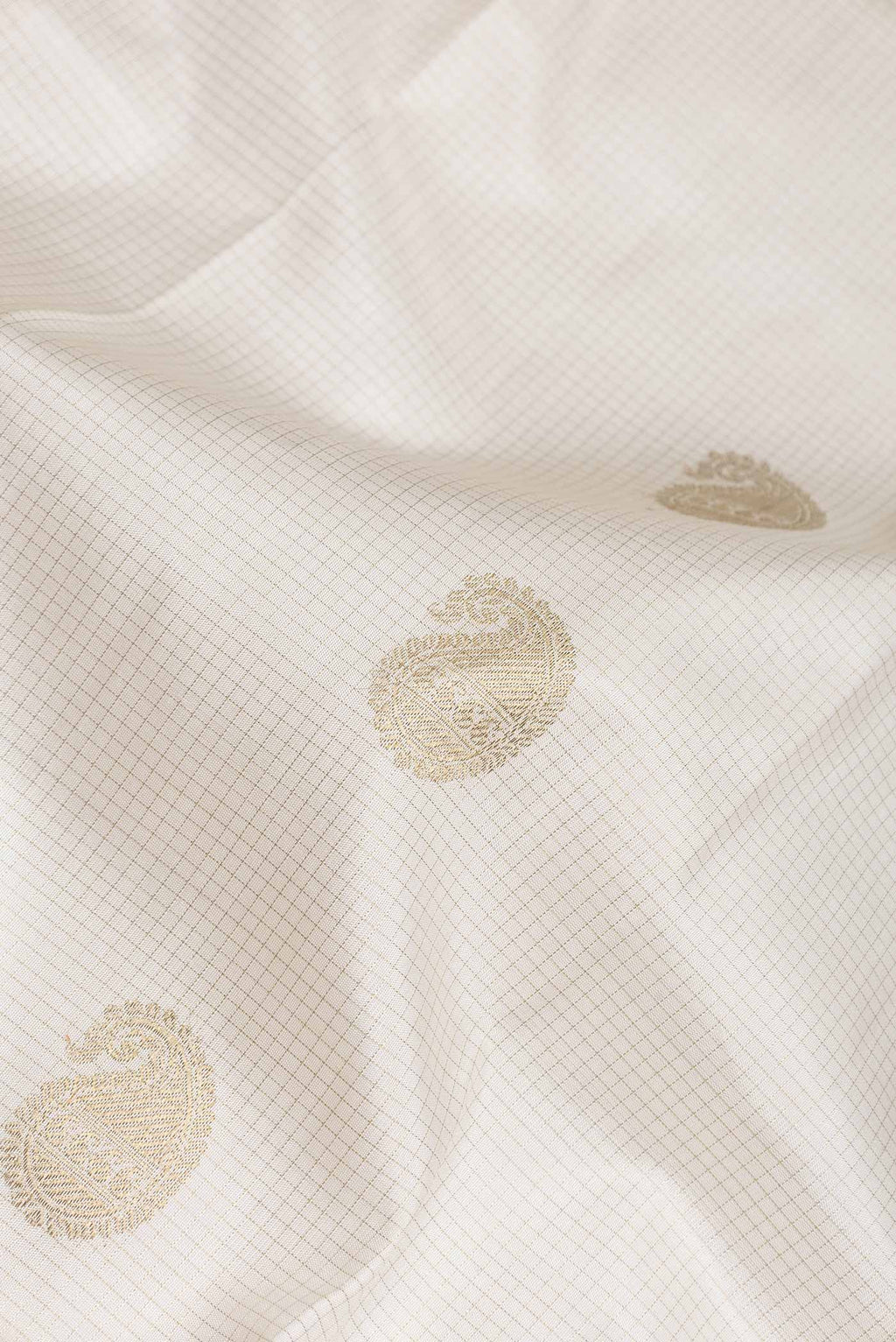 Close up of Pure Silk Pure Zari White Dual Tone Kanchipuram Saree with Checked design on the body and Zari Border displaying folds