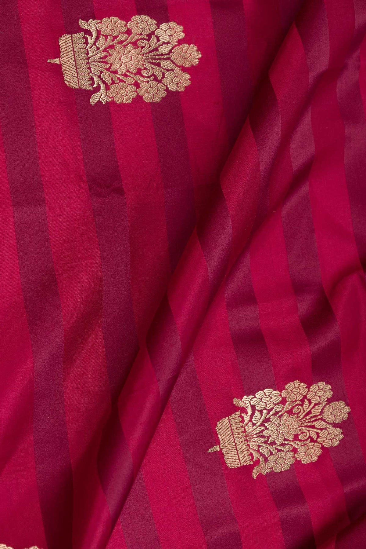 Close up of Pink Dual Tone Banarasi Saree with Zari Butta on the body and Zari Border displaying folds