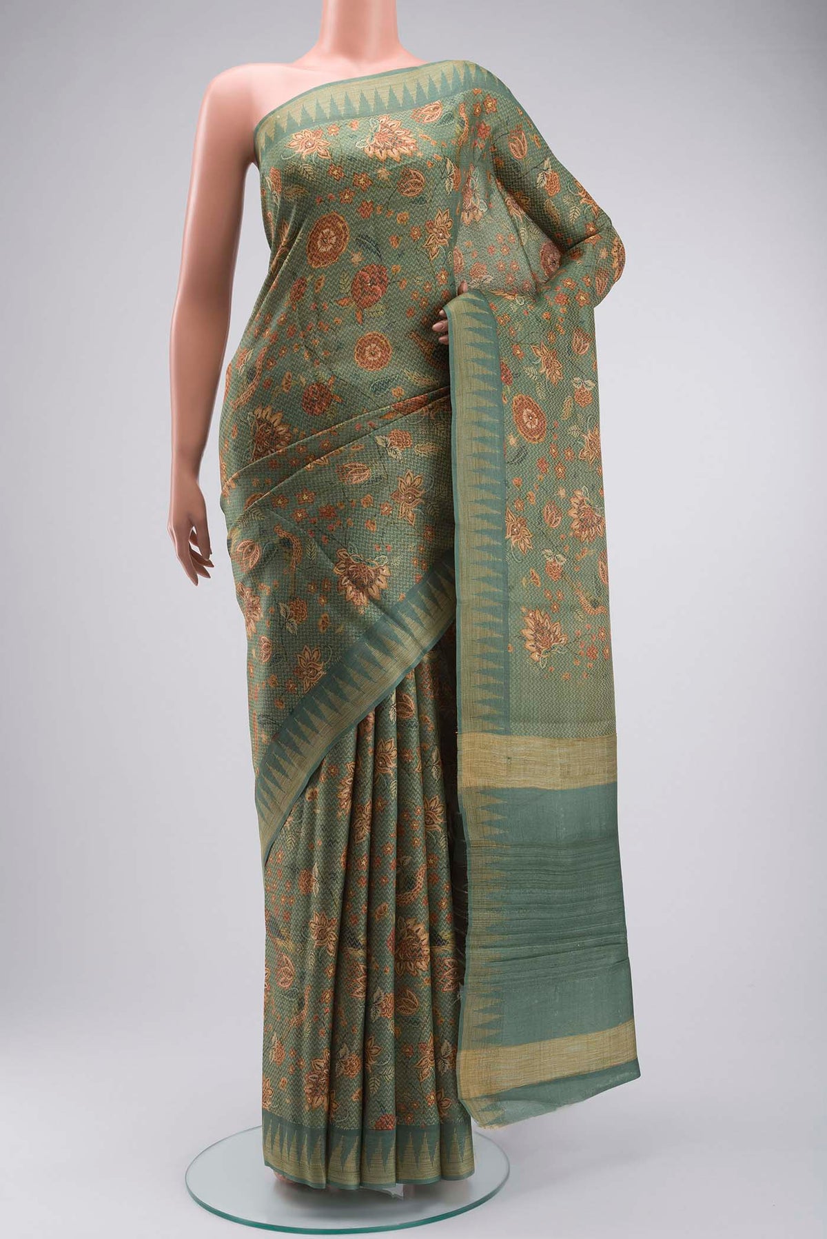 Green Tussar Silk Saree with Printed design on the body and Zari Border displayed on a mannequin