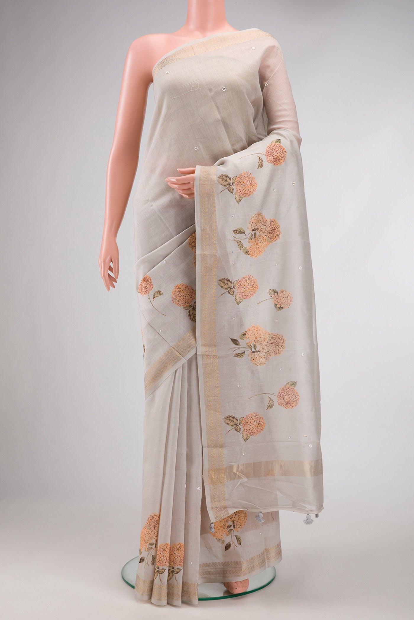 Grey Dual Tone Tussar Silk Saree with Printed design on the body and Zari Border.  displayed on a mannequin