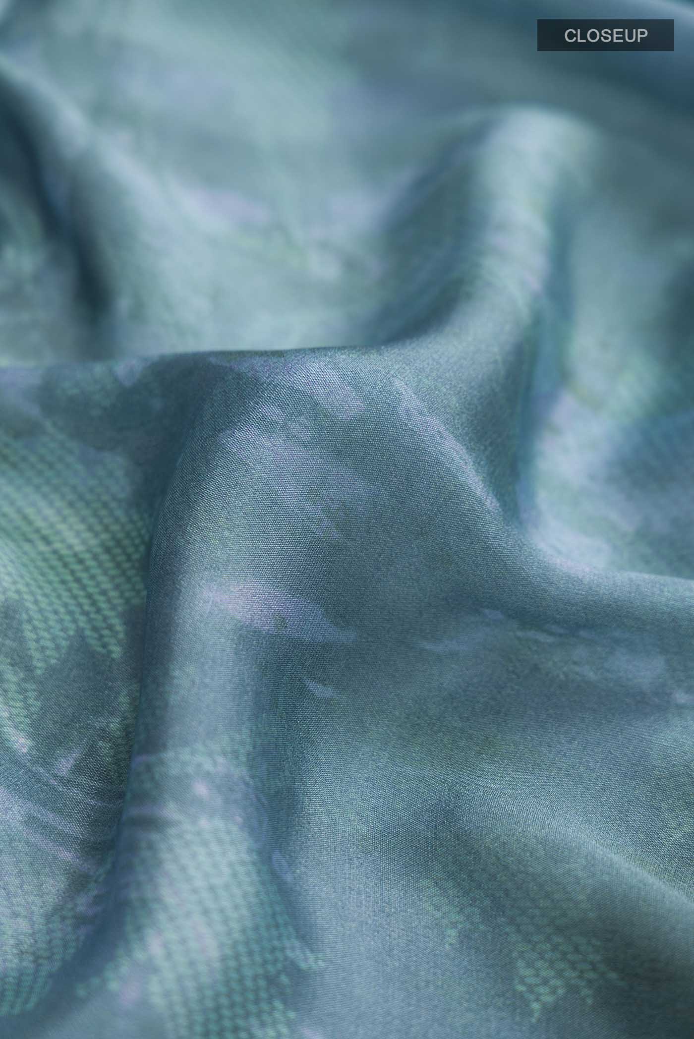 Close up of Blue Mysore Crepe Saree with Printed design on the body and Zari Border displaying folds
