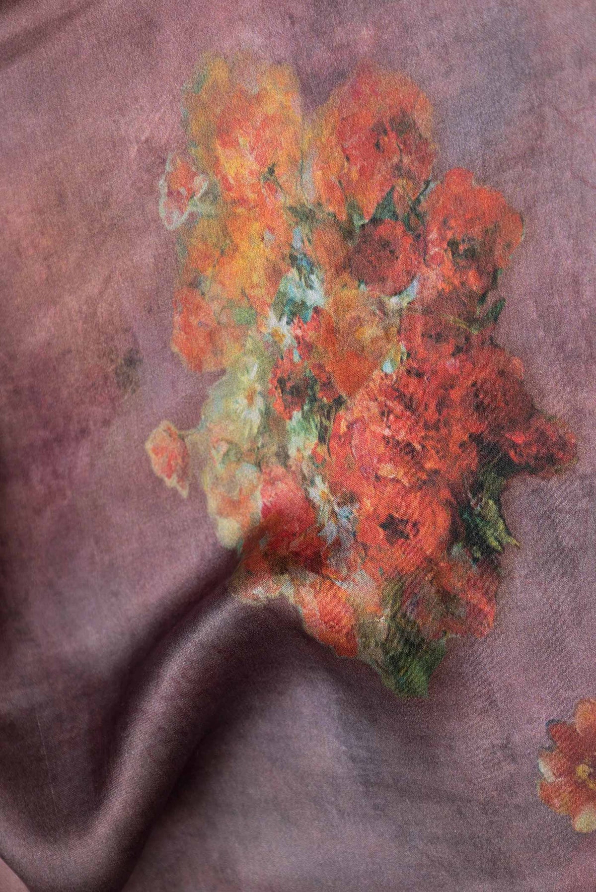 Close up of Mauve Satin Silk Saree with Floral Print on the body and Zari Border displaying folds