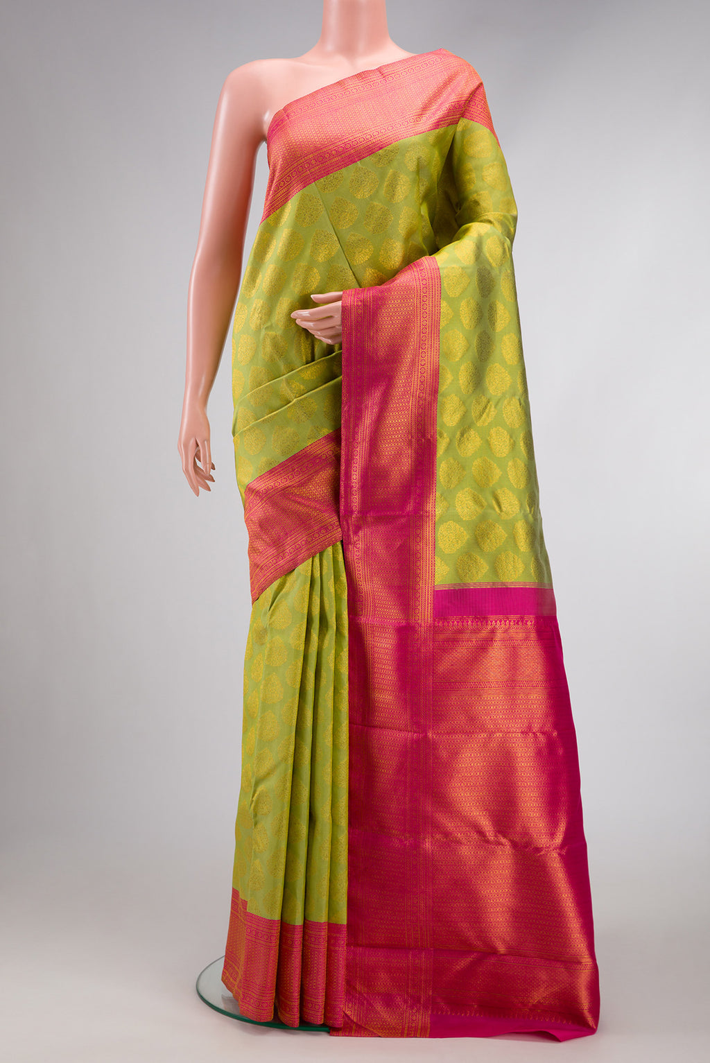 Parrot Green Dual Tone Kanjivaram Silk Saree with Zari Butta on the body and Zari Border.  displayed on a mannequin