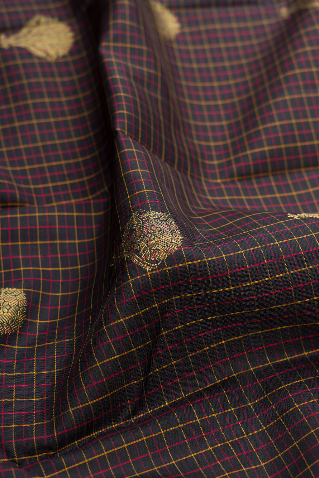 Close up of Brown Dual Tone Kanchipuram Silk Saree with Checked design on the body and Fancy Border.  displaying folds