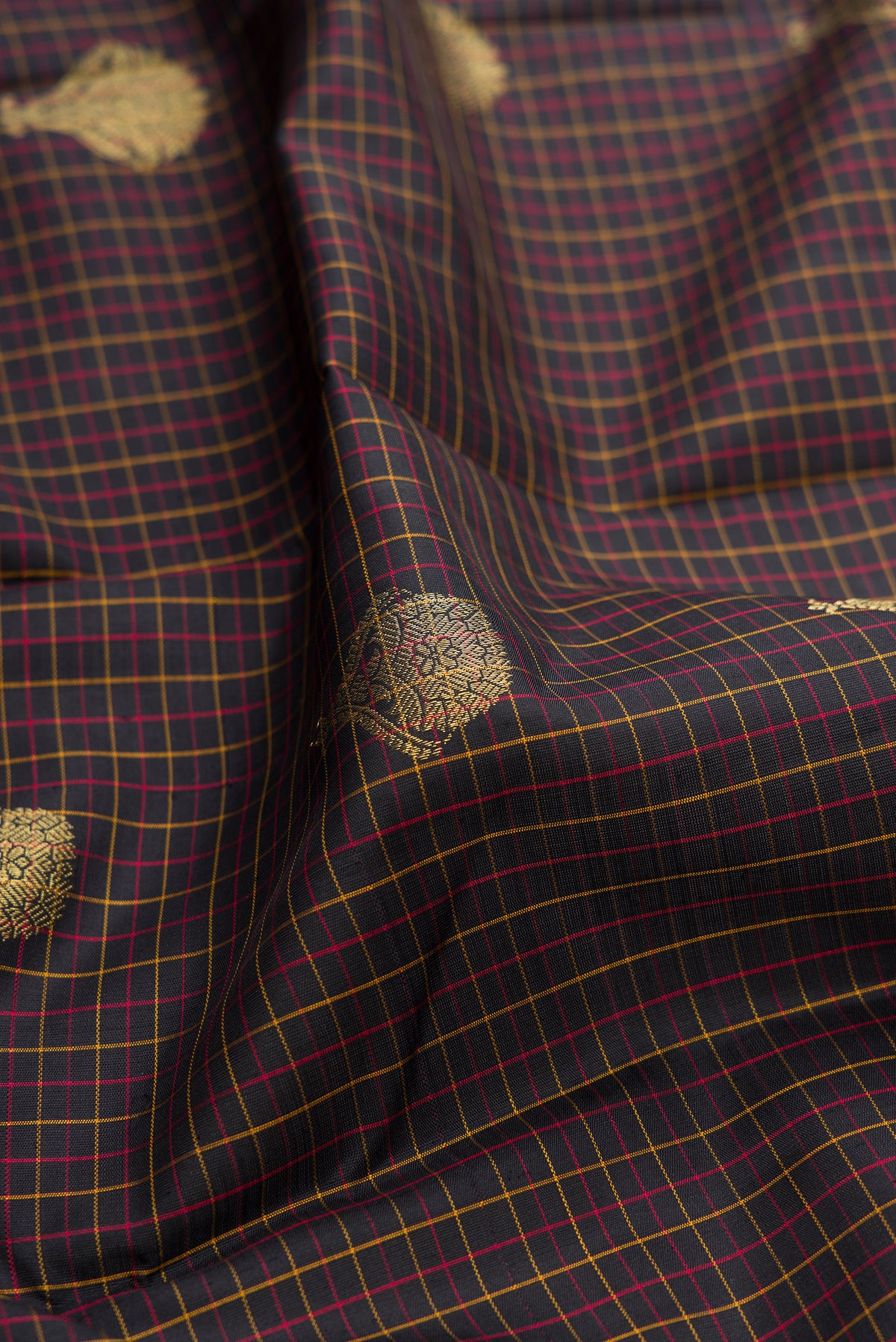 Close up of Brown Dual Tone Kanchipuram Silk Saree with Checked design on the body and Fancy Border.  displaying folds