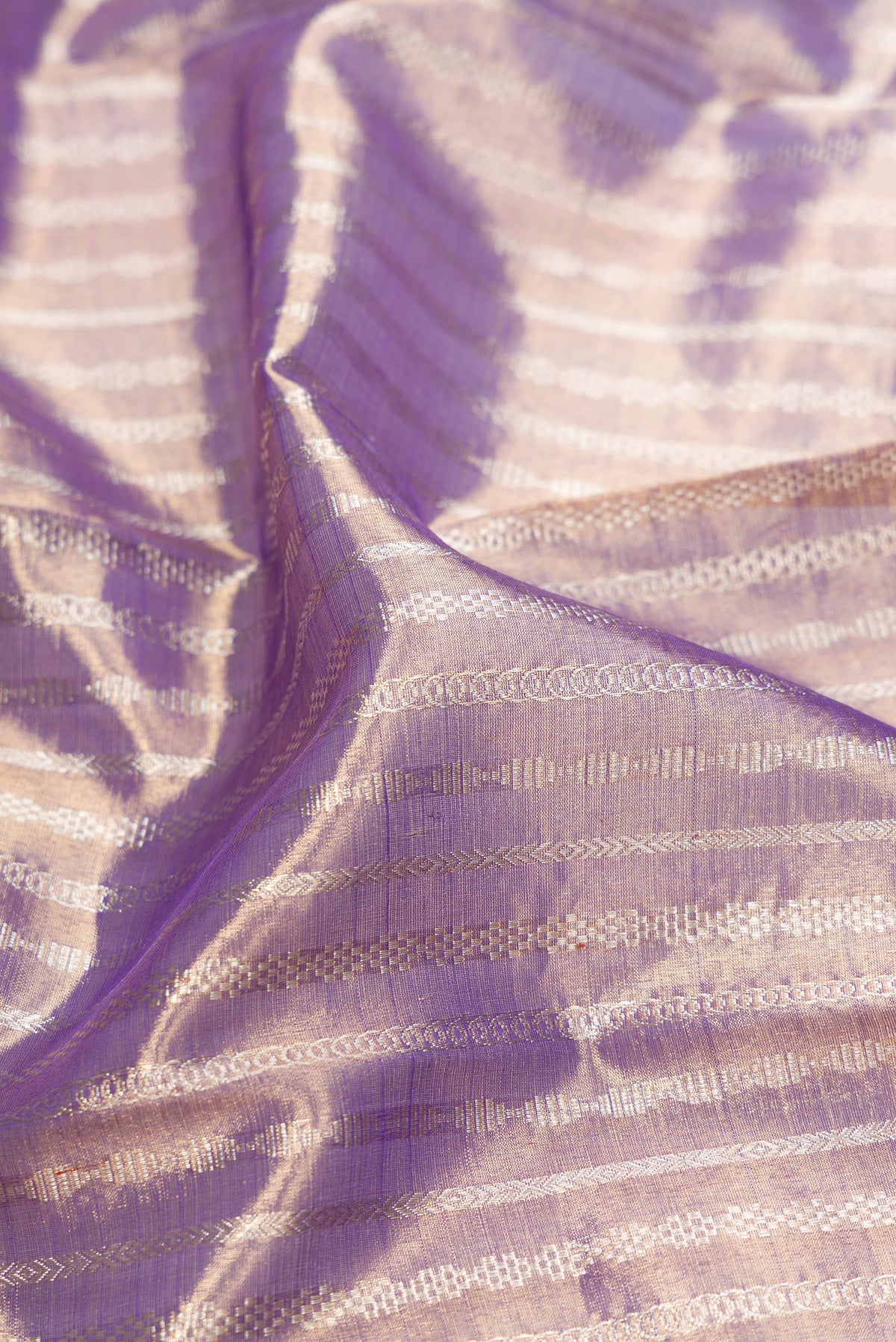 Close up of Purple Dual Tone Kanjivaram Tissue Silk Saree with Zari Brocade on the body and Zari Border.  displaying folds