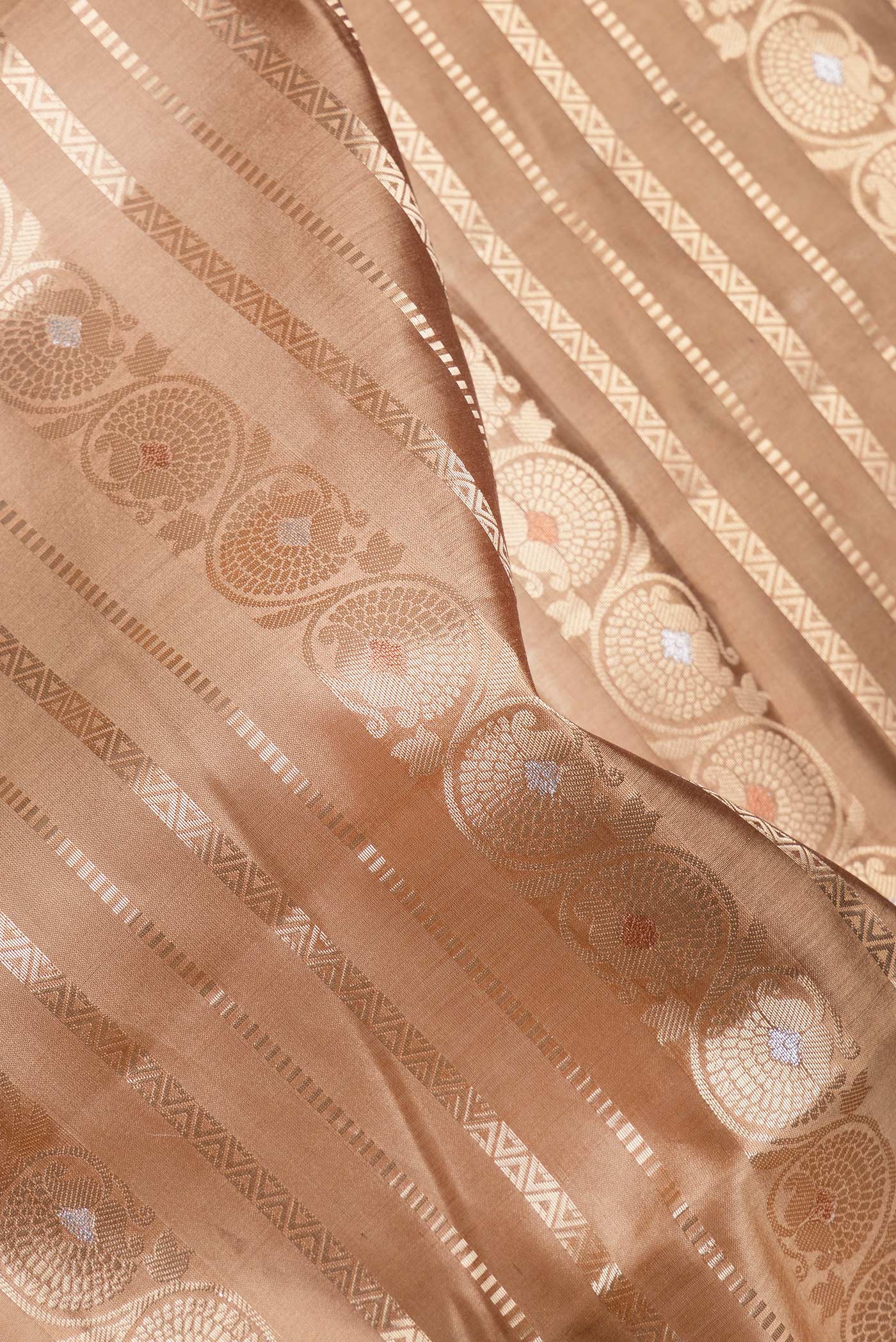 Close up of Brown Dual Tone Tussar Silk Saree with Stripes on the body and Zari Border.  displaying folds