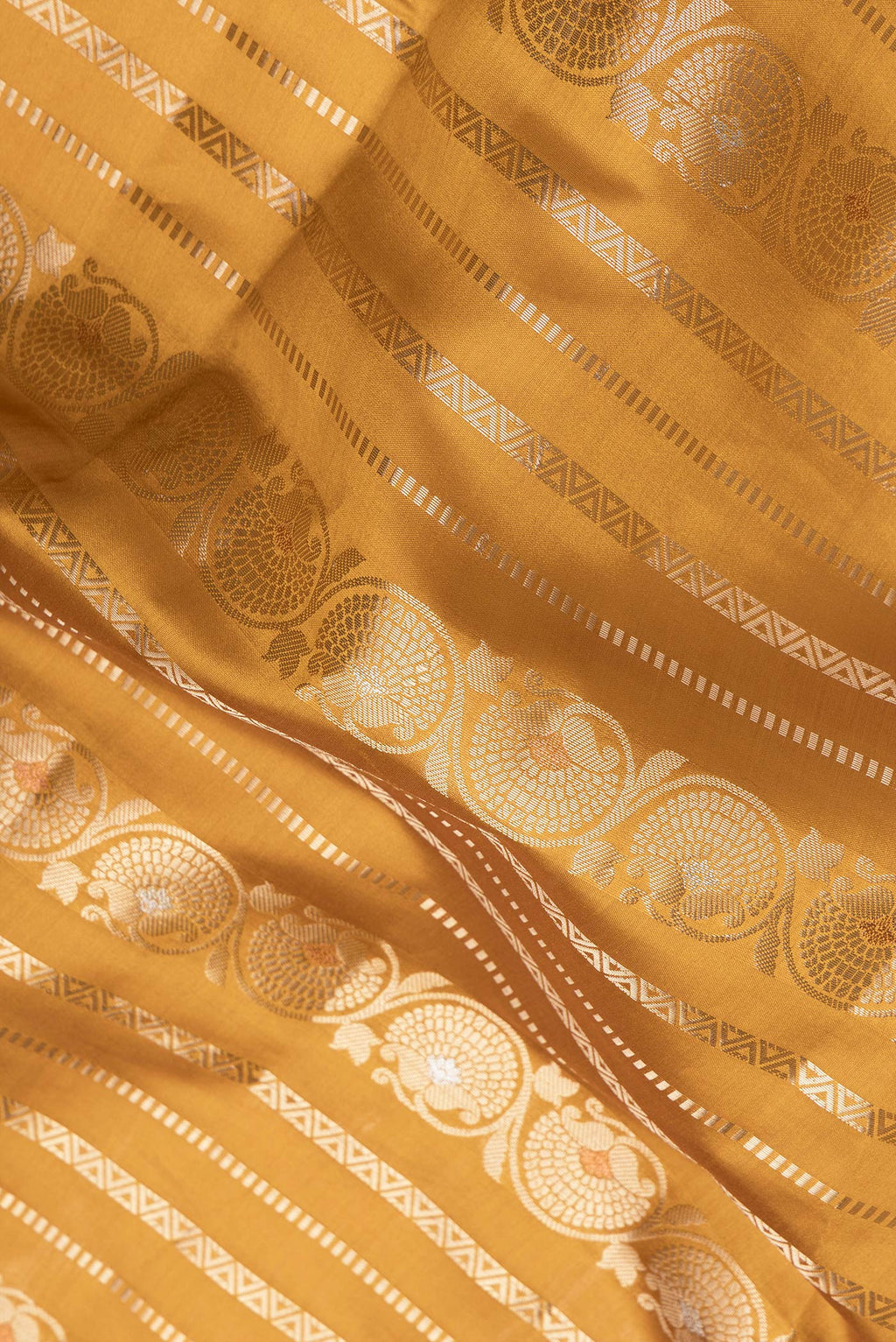 Close up of Mustard Dual Tone Tussar Silk Saree with Stripes on the body and Zari Border.  displaying folds