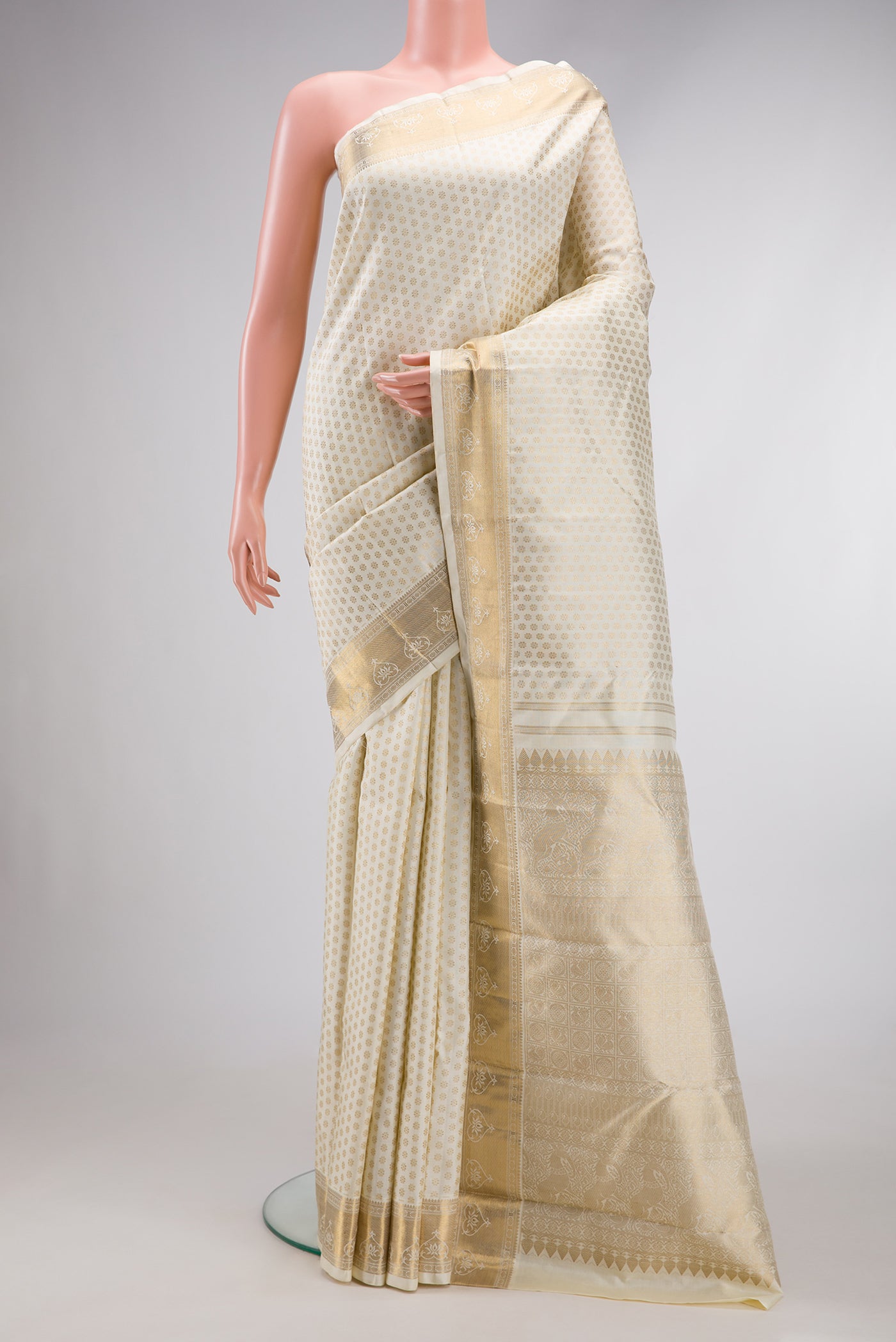 Pure Silk Pure Zari Off White Dual Tone Kanjivaram Saree with Zari Brocade on the body and Zari Border.  displayed on a mannequin