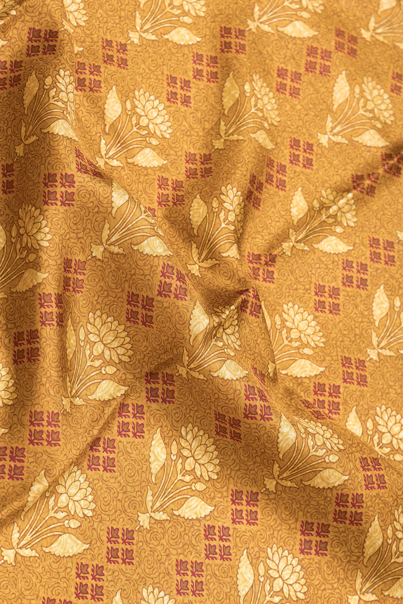 Close up of Mustard Dual Tone Printed Silk Saree with Printed design on the body and Printed Border.  displaying folds