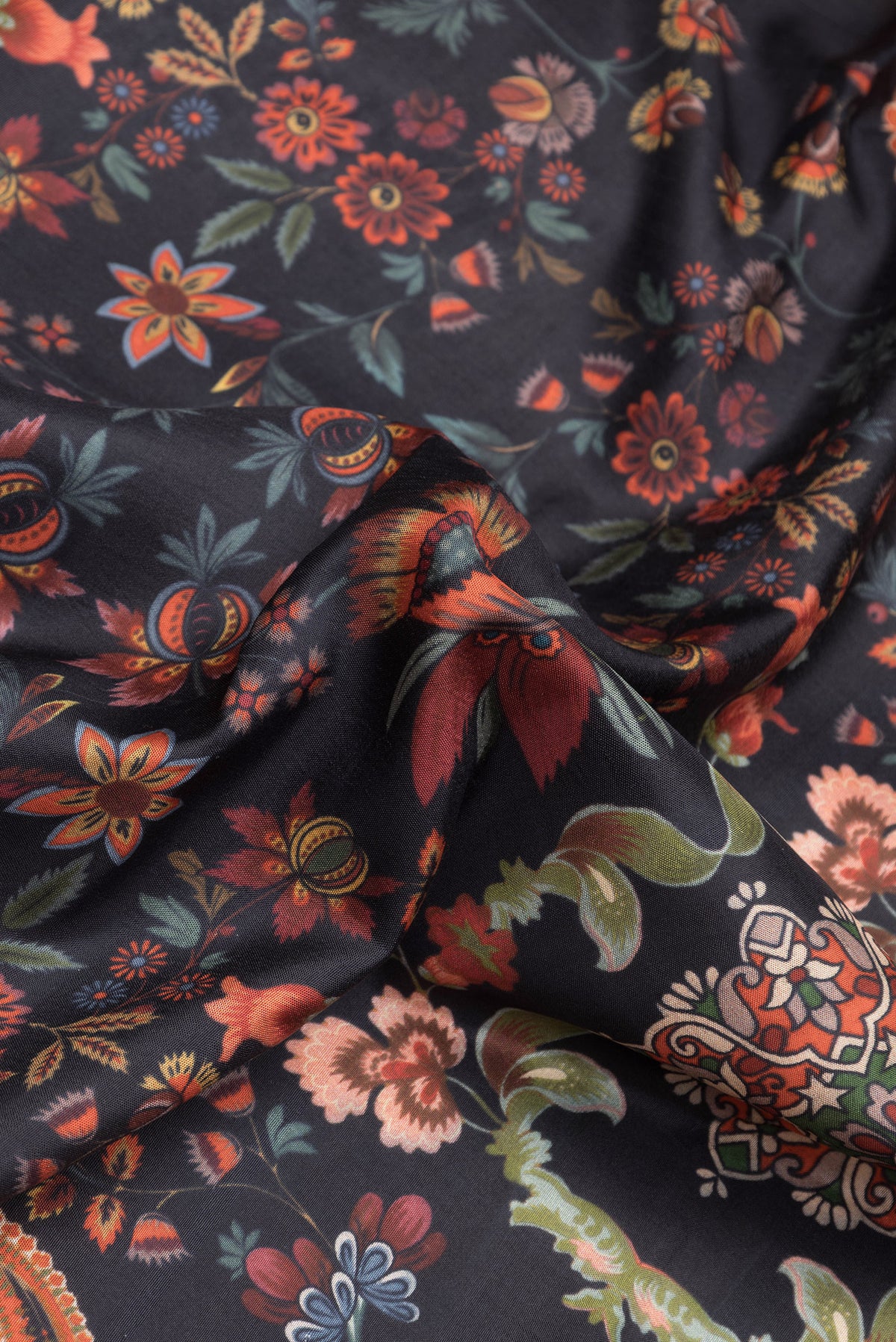 Close up of Black Dual Tone Kanjivaram Silk Saree with Printed design on the body and Zari Border.  displaying folds