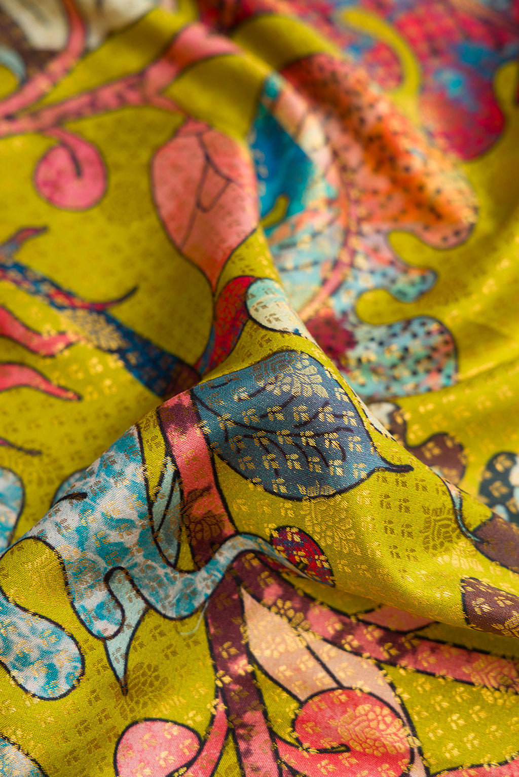 Close up of Green Kanjivaram Silk Saree with Printed design on the body and Zari Border.  displaying folds