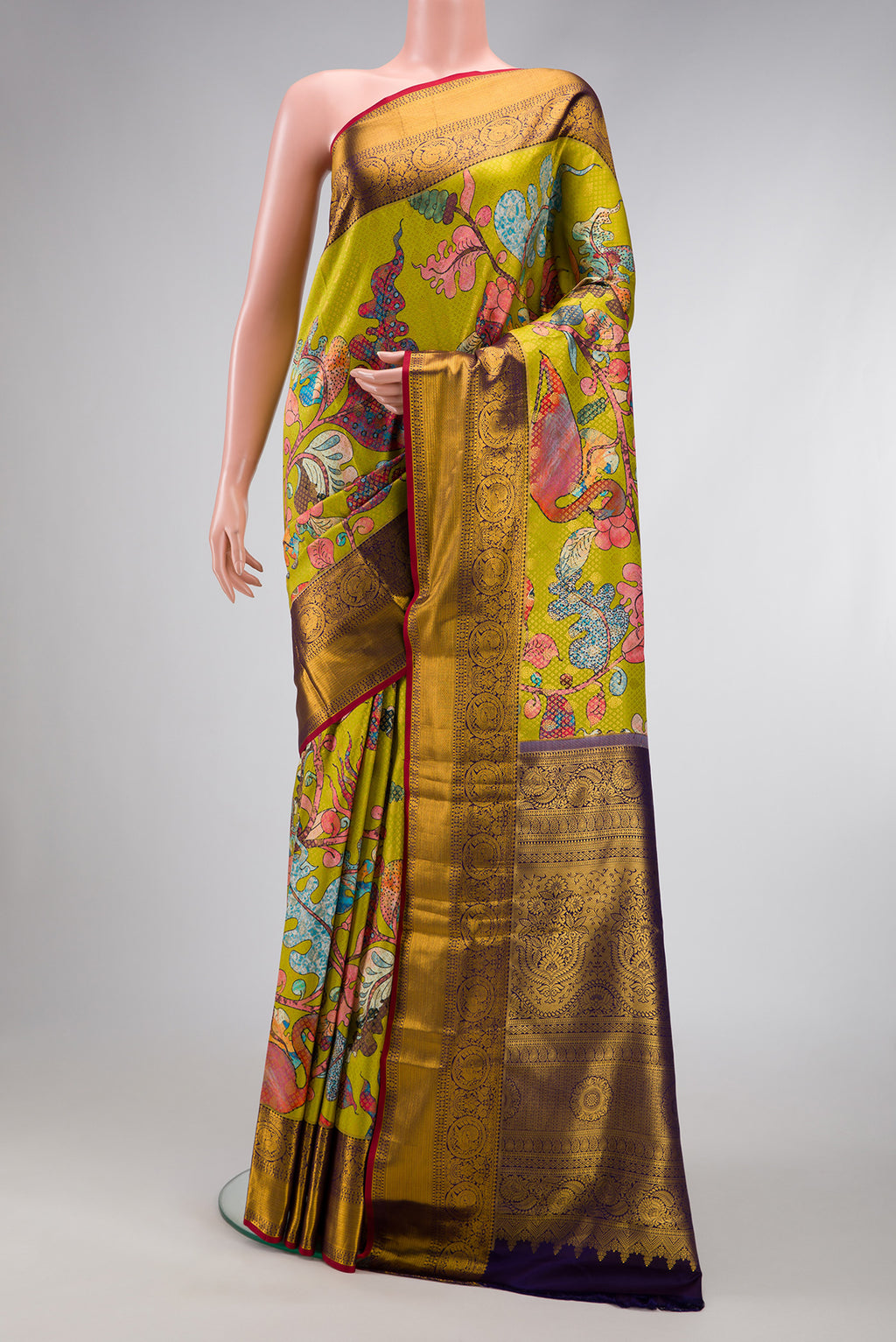 Green Kanjivaram Silk Saree with Printed design on the body and Zari Border.  displayed on a mannequin