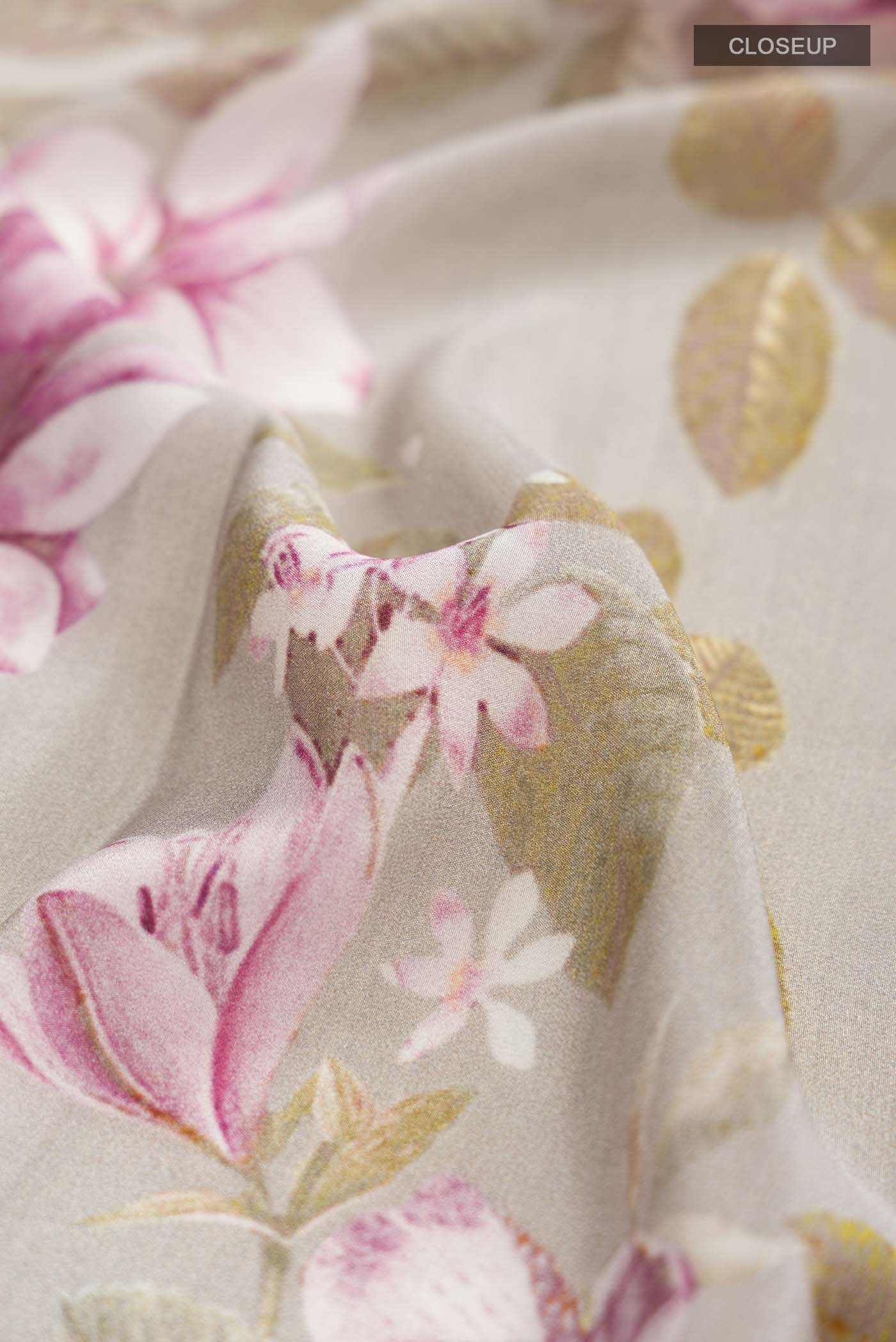 Close up of Grey Mysore Crepe Saree with Floral Print on the body and Printed Border displaying folds