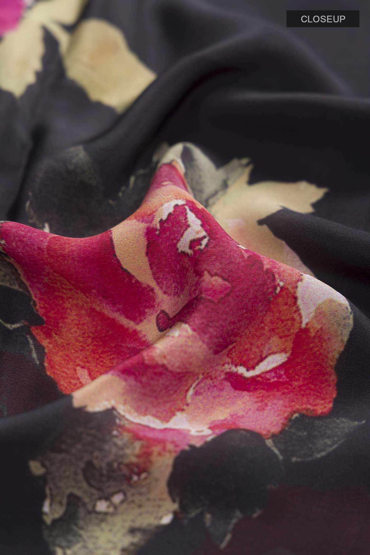 Close up of Black Mysore Crepe Saree with Floral Print on the body and Without Border displaying folds