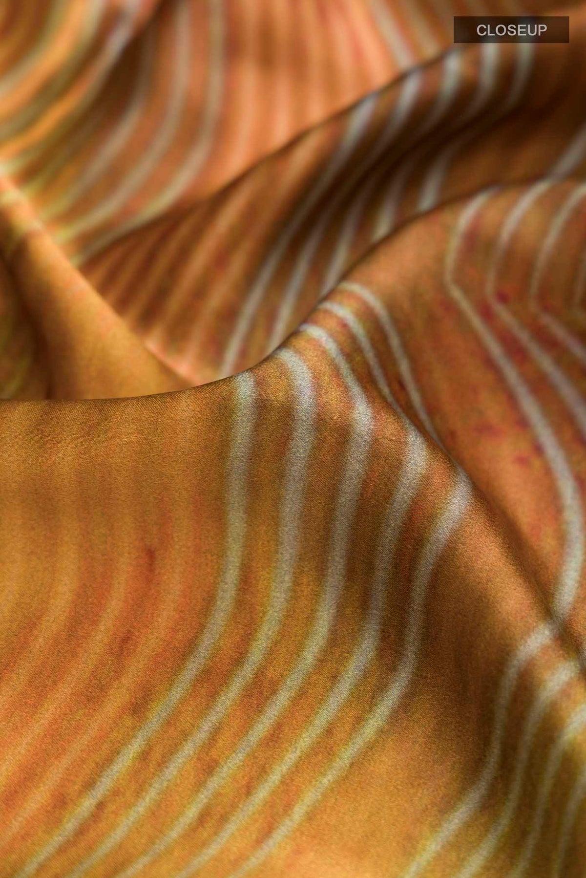 Close up of Multi Color Satin Silk Saree with Abstract Print on the body and Plain Border displaying folds