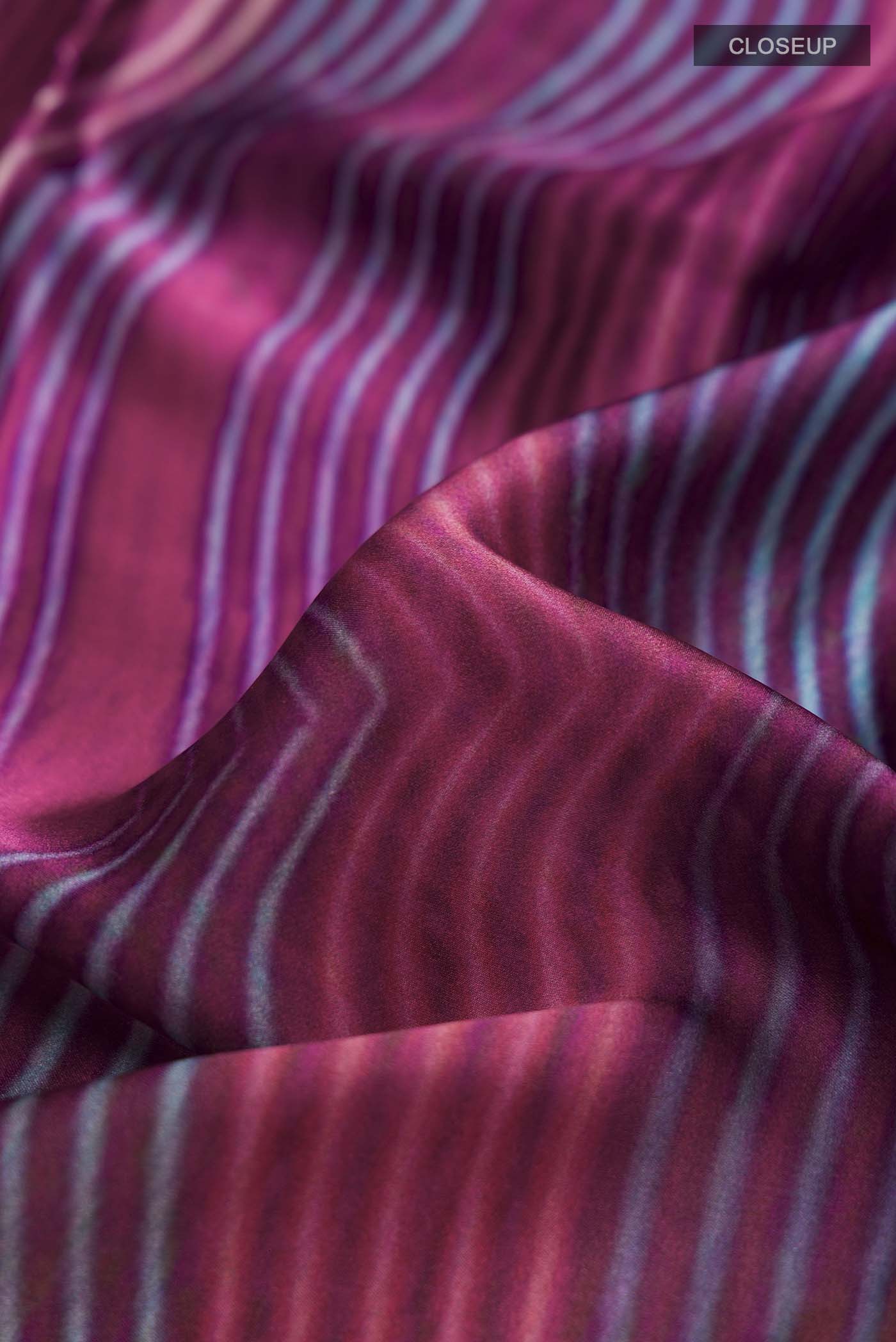 Close up of Multi Color Satin Silk Saree with Abstract Print on the body and Plain Border displaying folds